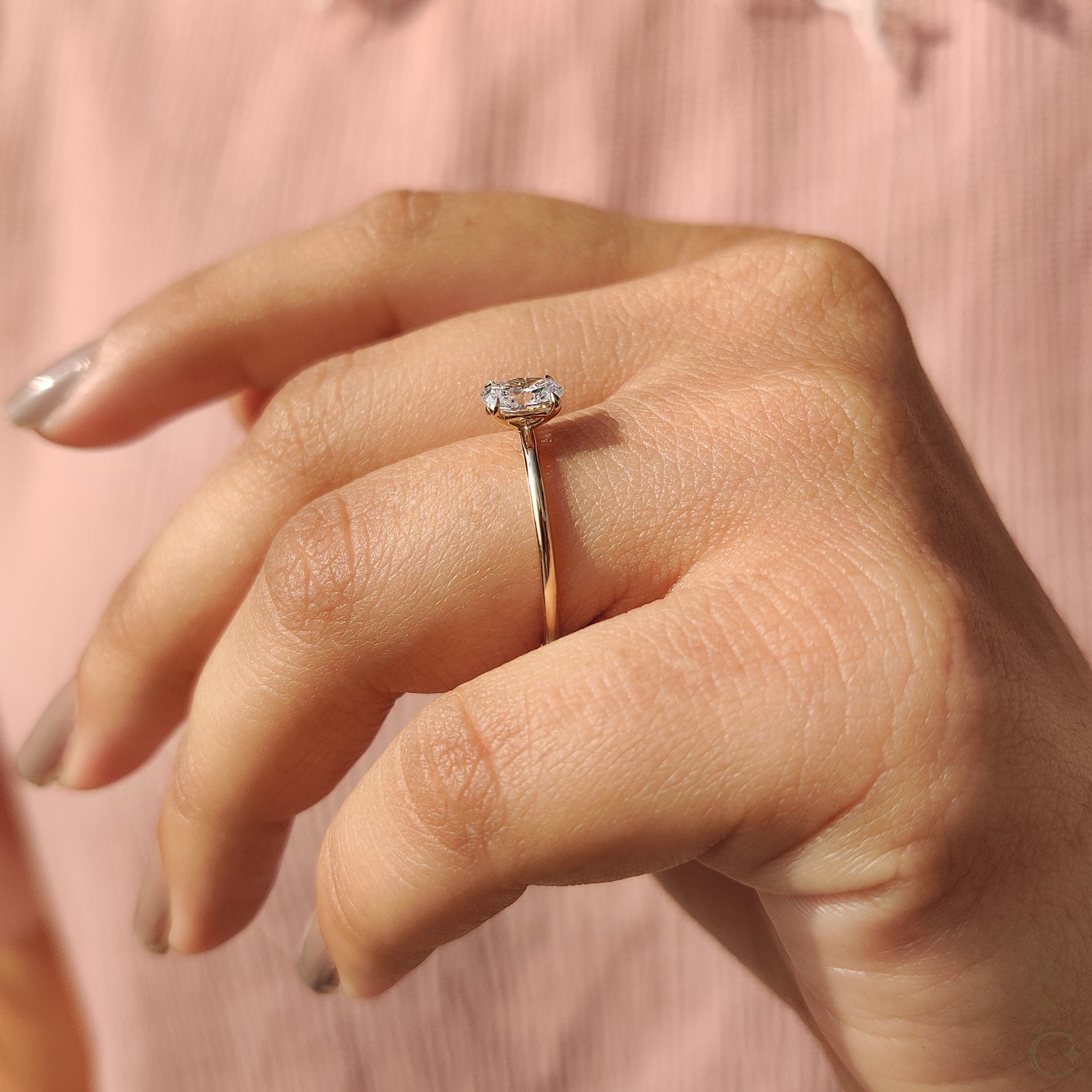 Yellow gold engagement ring with an oval cut diamond.
