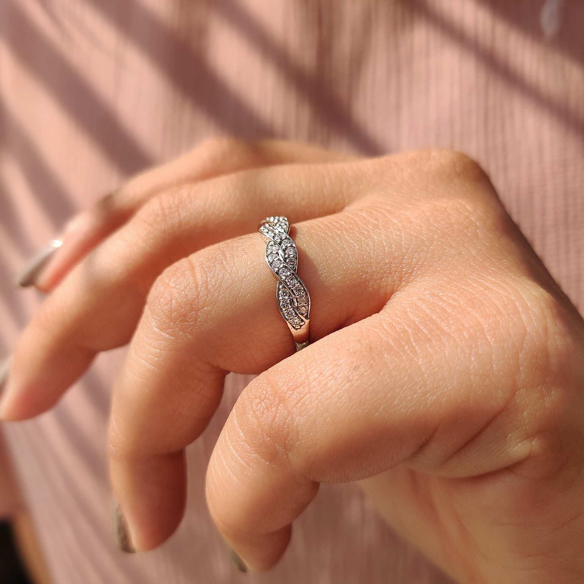 Elegant white gold wedding band with twisted design.

