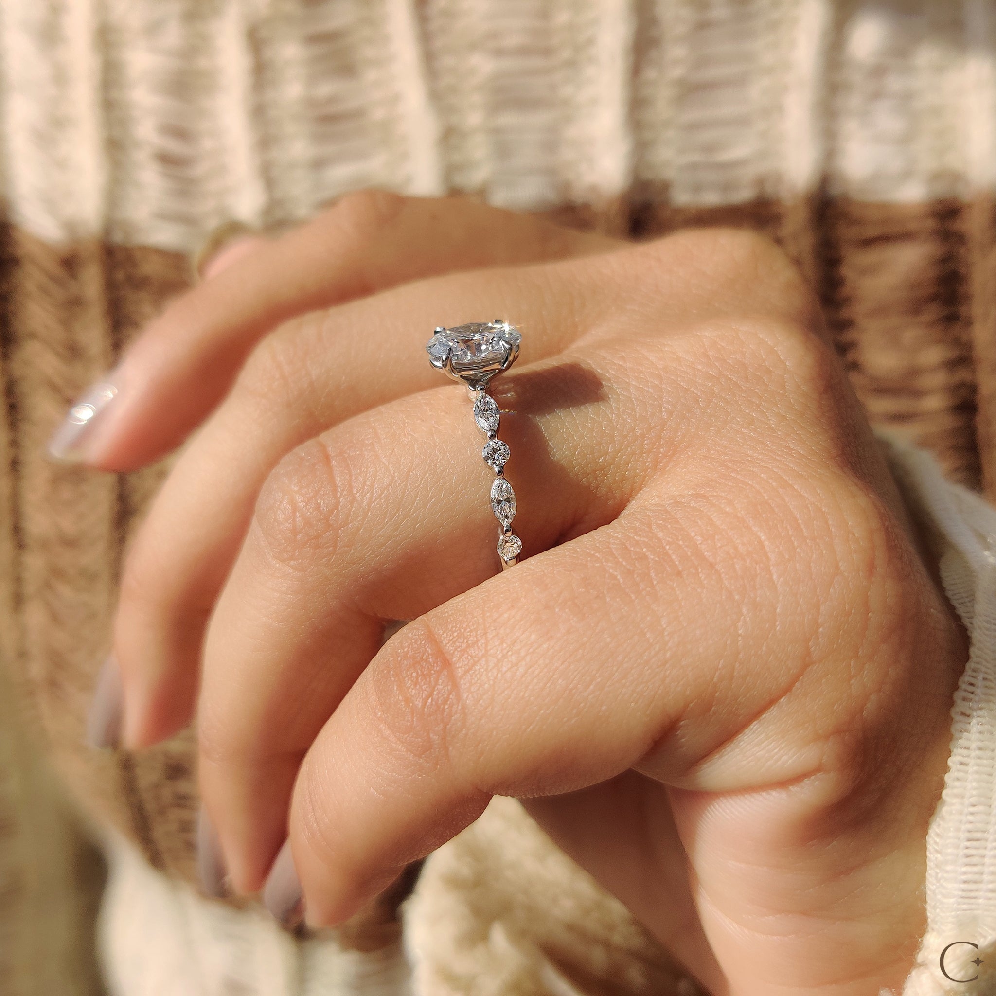 Round and marquise side stone engagement ring.
