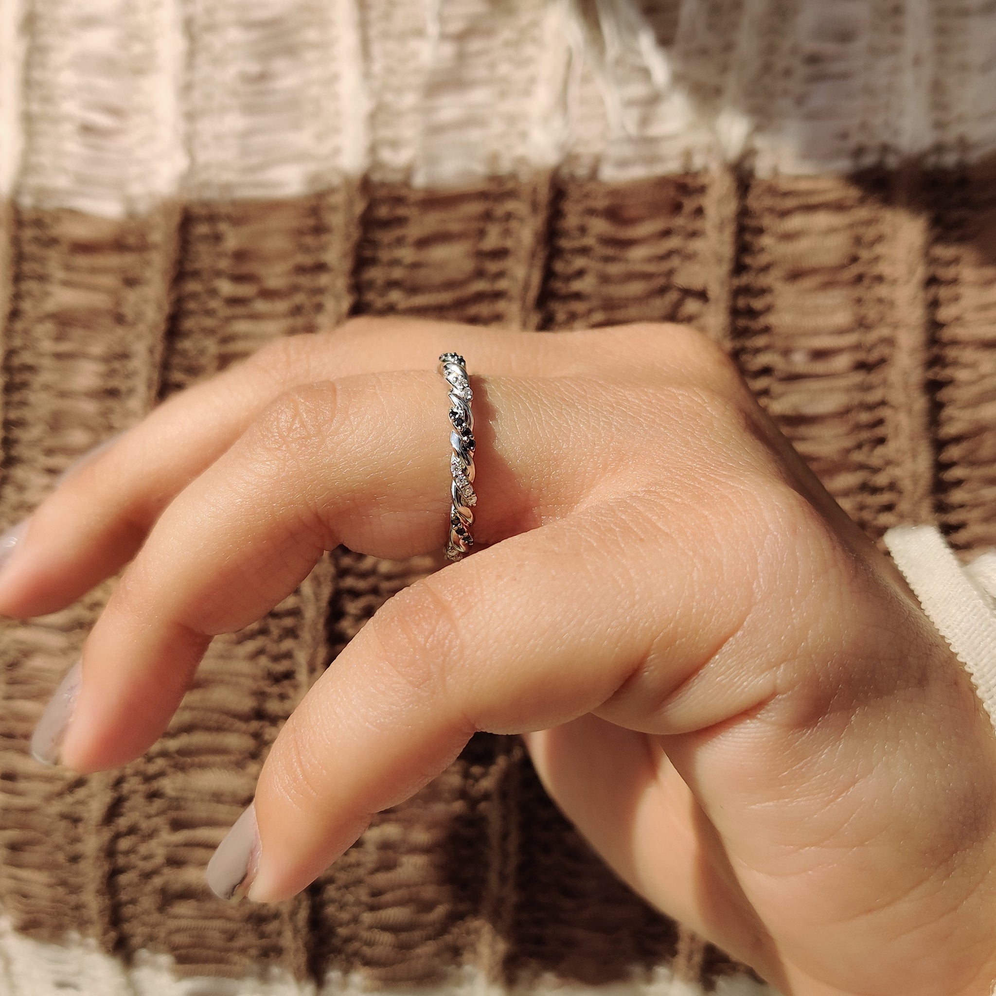 Black moissanite wedding band in twisted gold style.
