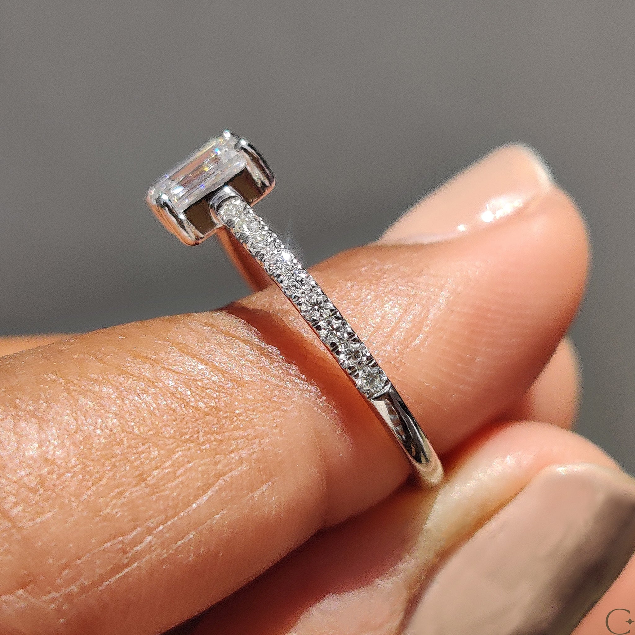 Carat Diamonds engagement ring with emerald pave setting.
