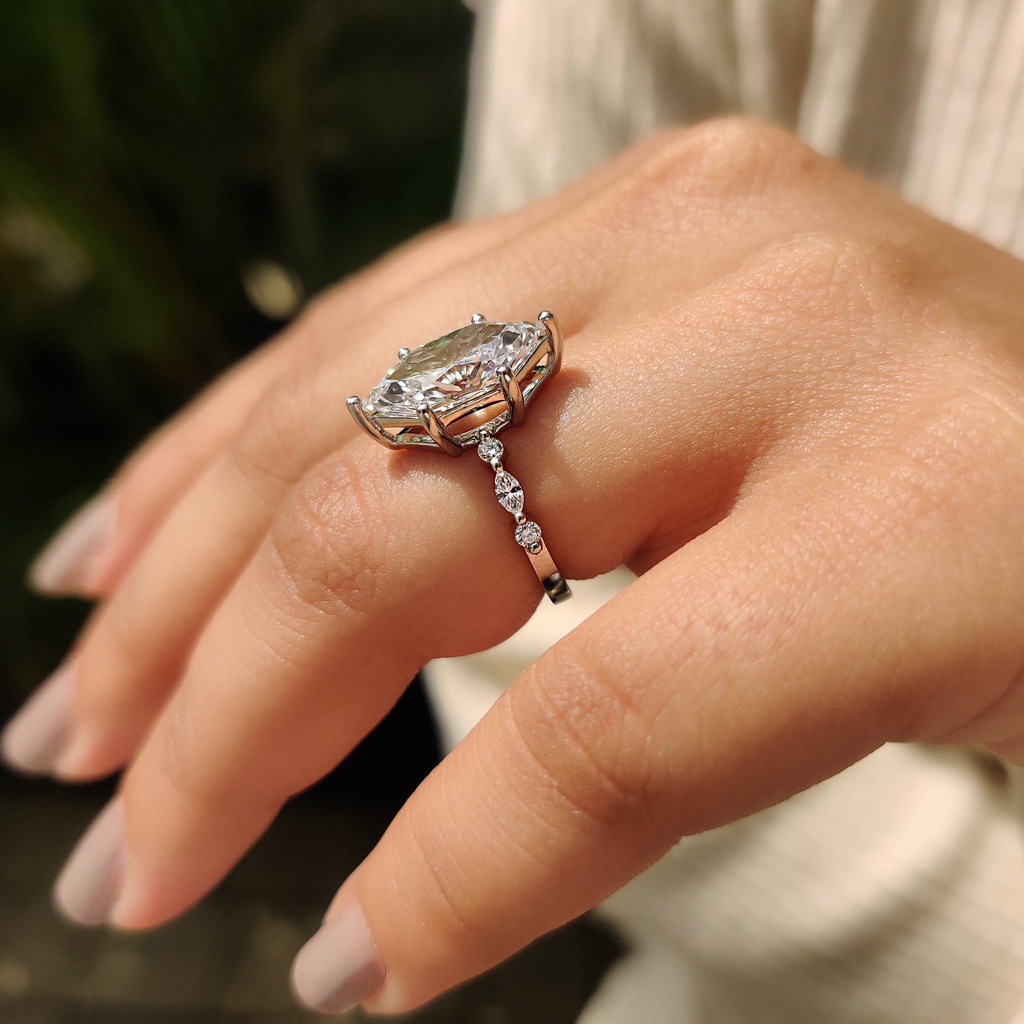 Marquise and round side stone in ring.
