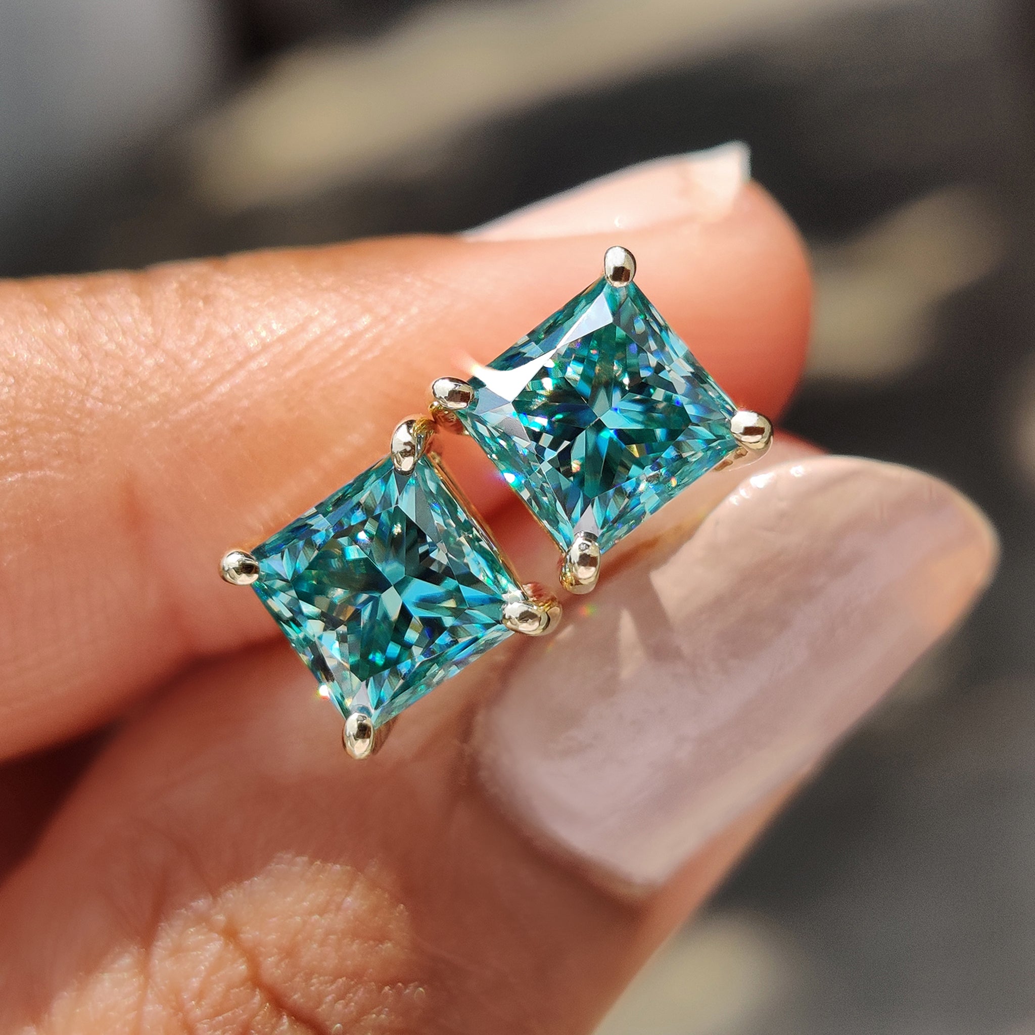Cyan Blue Princess Cut Moissanite earrings crafted in yellow gold earrings with 4 prong settings earrings.
