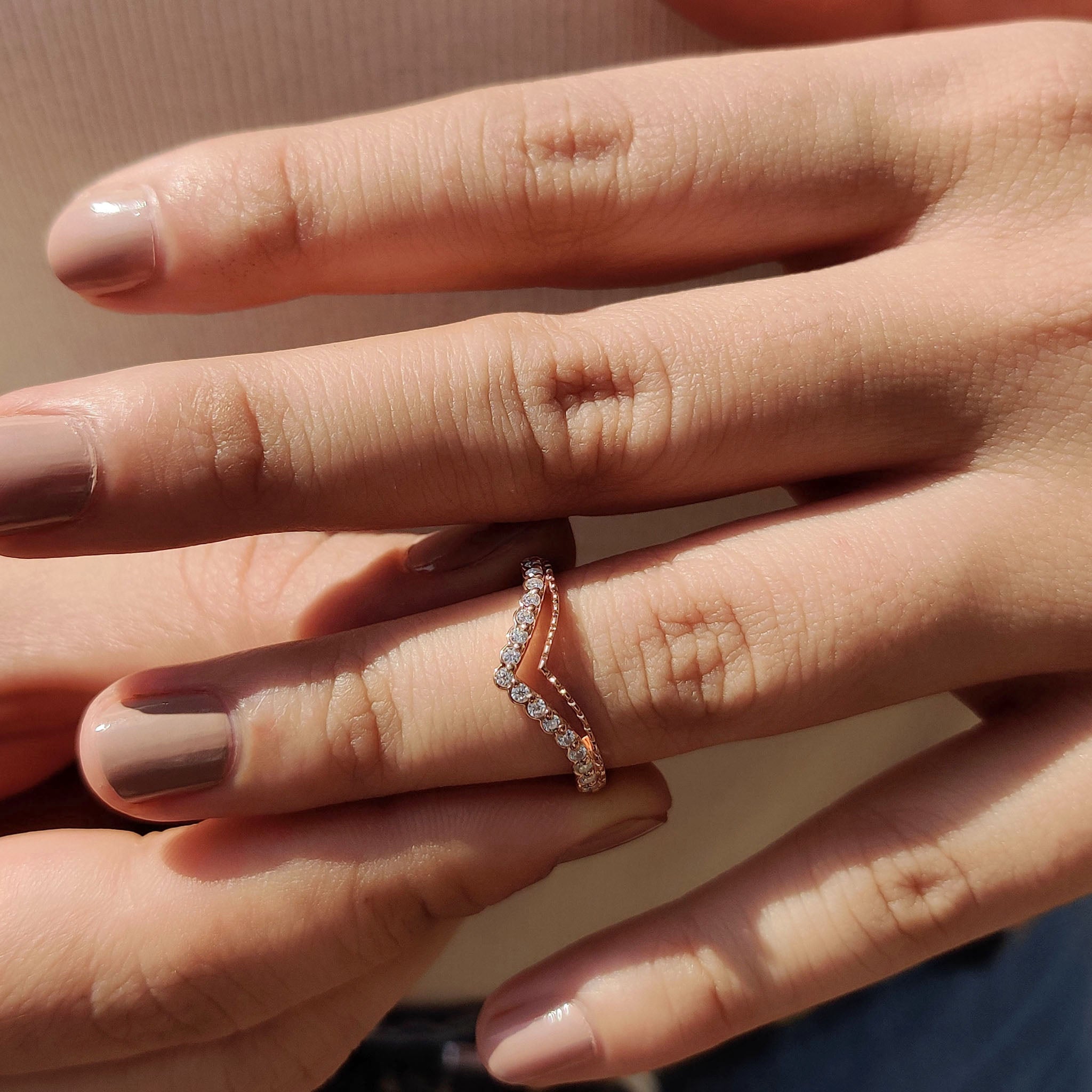 Rose gold chevron wedding band with Moissanite stones.