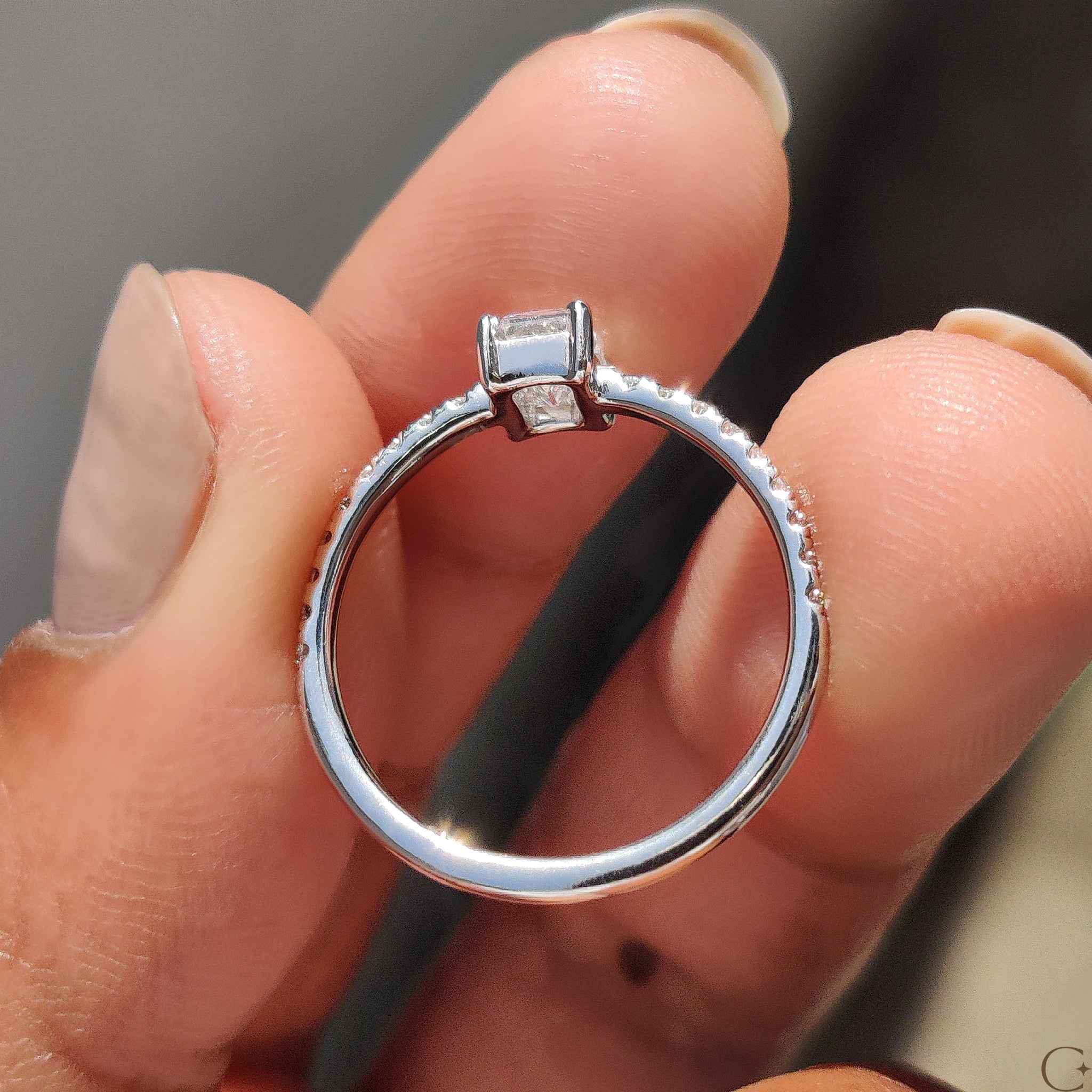 Stunning emerald pave ring with a brilliant emerald cut diamond.
