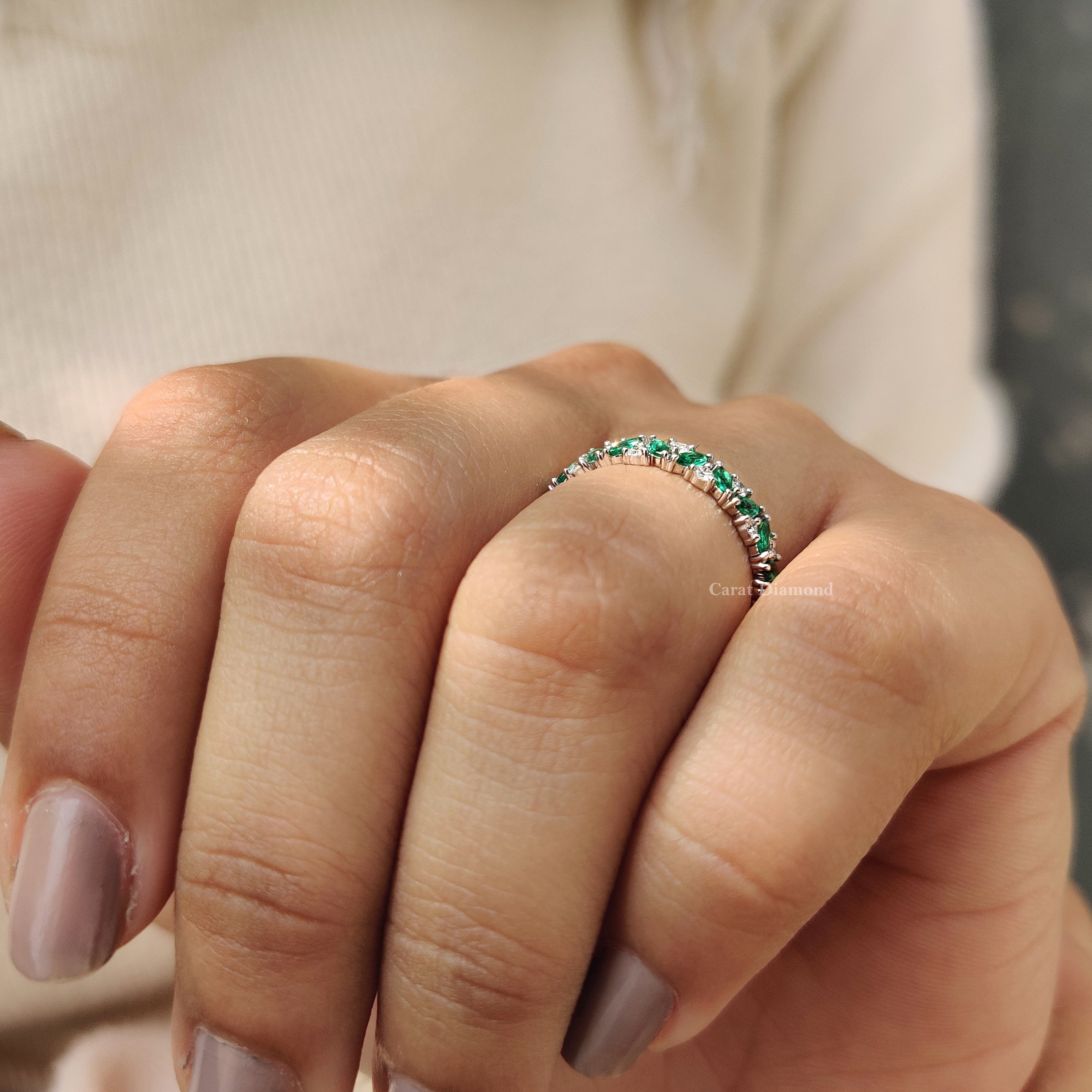 Green emerald eternity band with continuous sparkle.
