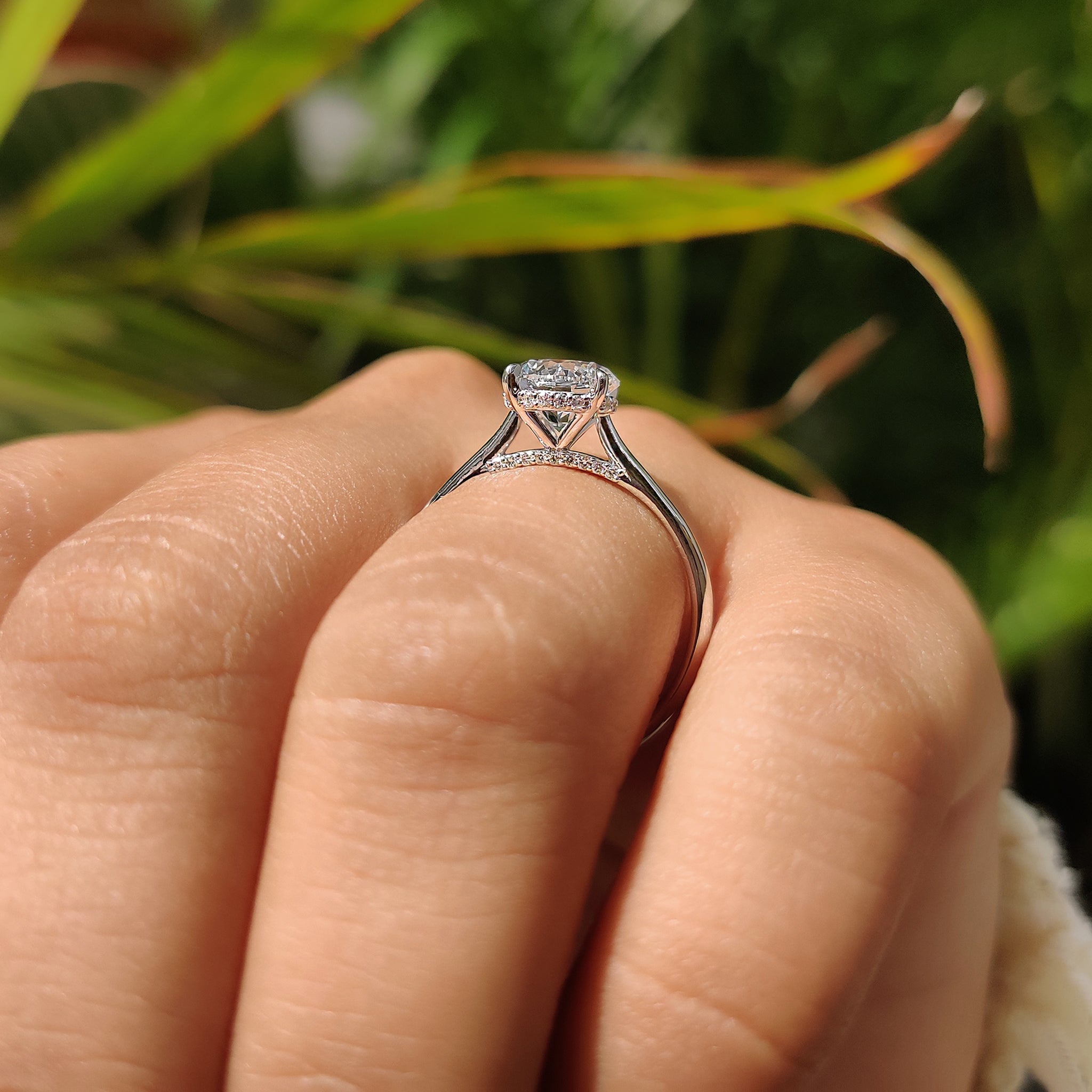 Hidden halo engagement ring with bridge accent ring.