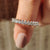 Round wedding band with full diamond eternity design in white gold.
