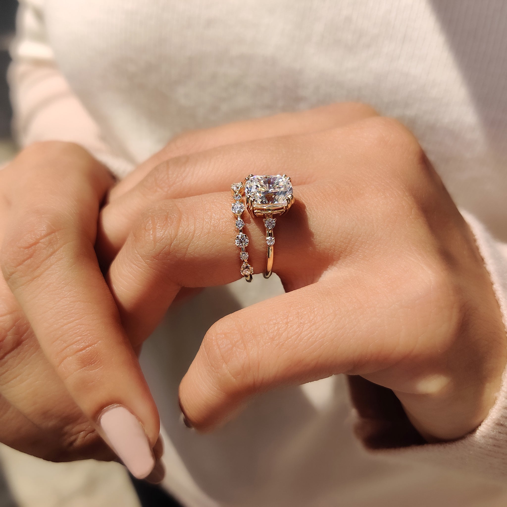 Custom engagement ring with cushion and round moissanite.
