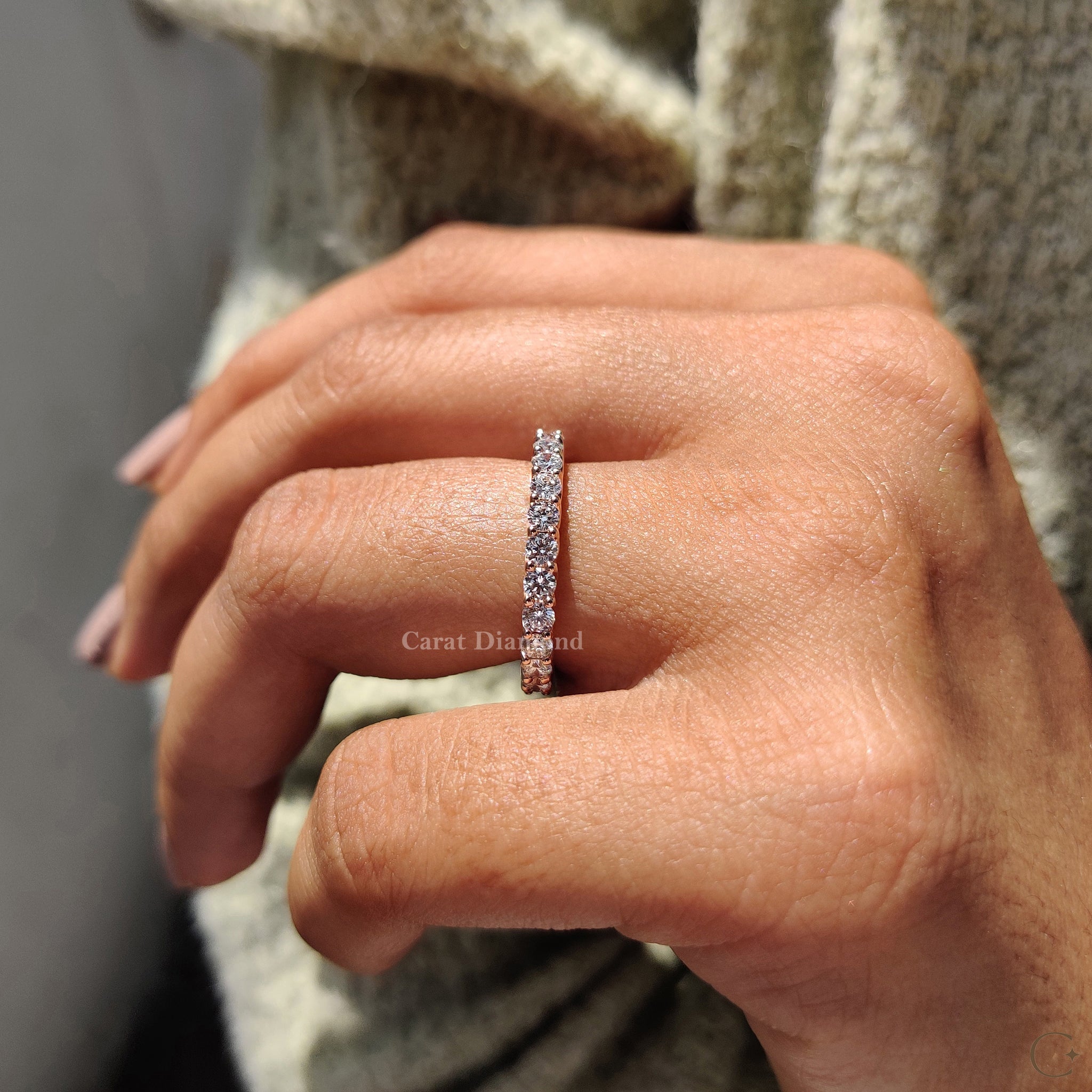 Eternity diamond wedding band placed on a soft fabric for display.