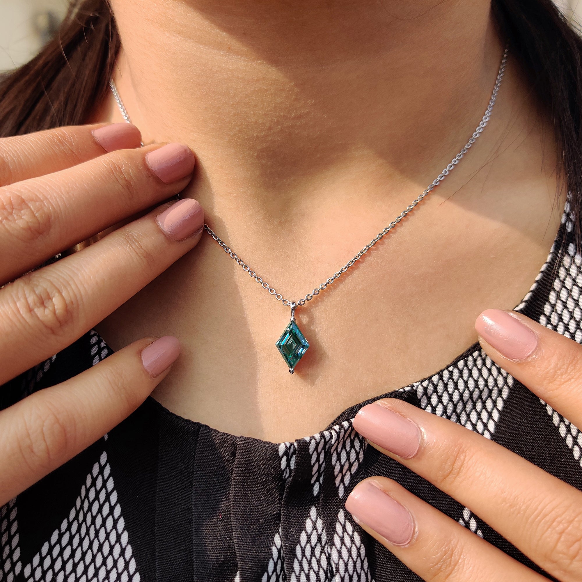 Lozenge Step Cut cyan blue Moissanite featured in cayn blue moissanite pendant.
