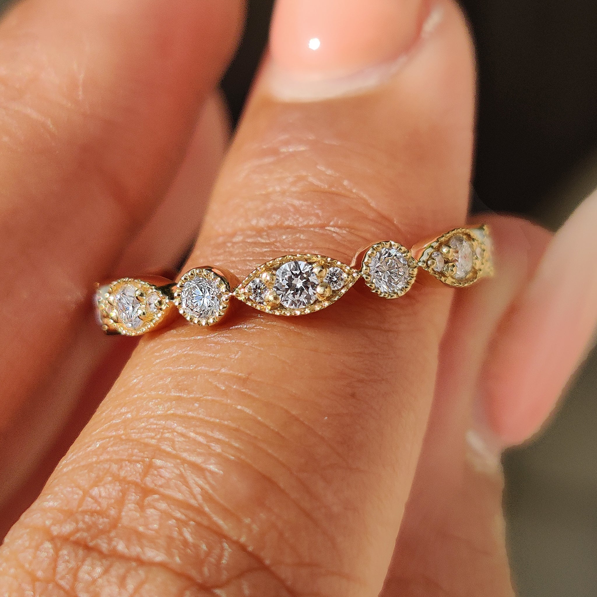 Round diamond eternity band shown on a white background.

