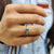 The green stone moissanite ring shines with a vibrant, eco-friendly touch.