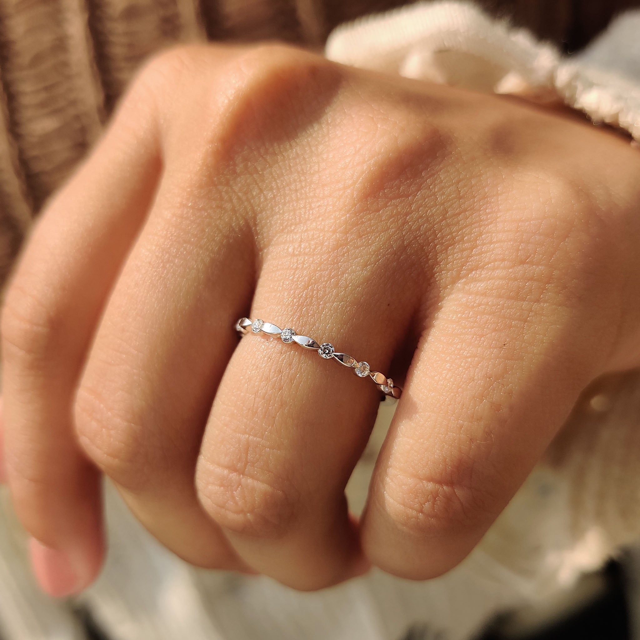Buy wedding band with stackable white gold band and distance pave diamonds.
