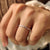 Buy wedding band with stackable white gold band and distance pave diamonds.
