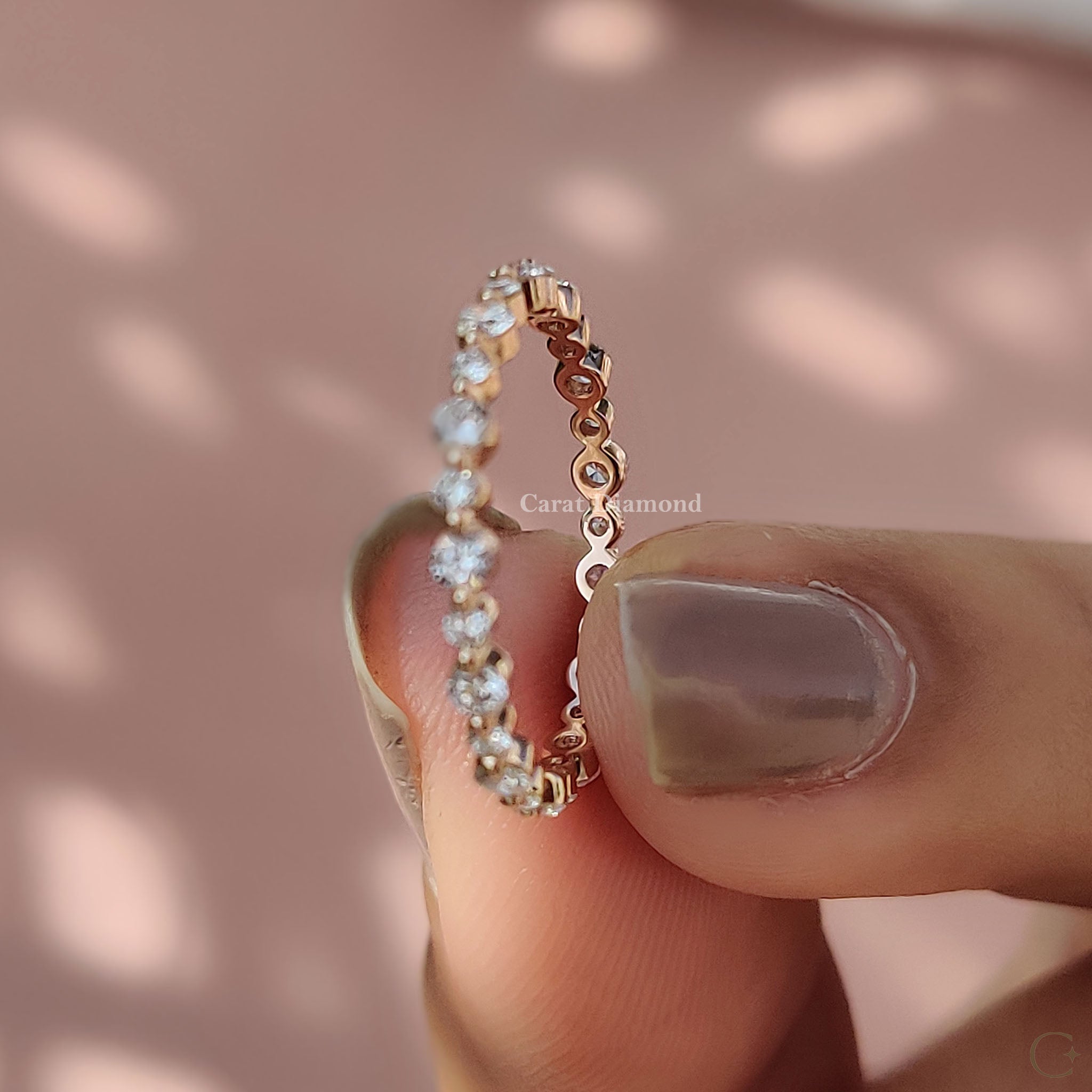 Rose gold anniversary band featuring round-cut diamonds.