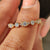 Round diamond eternity band shown on a white background.
