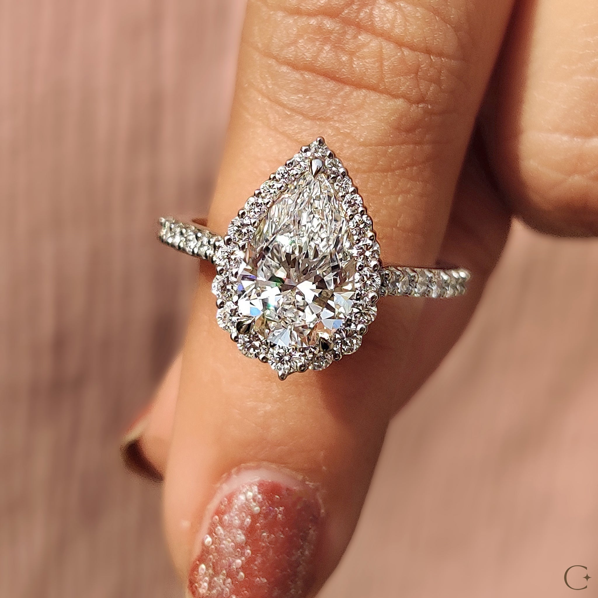 Cathedral setting with a pear shaped diamond center.
