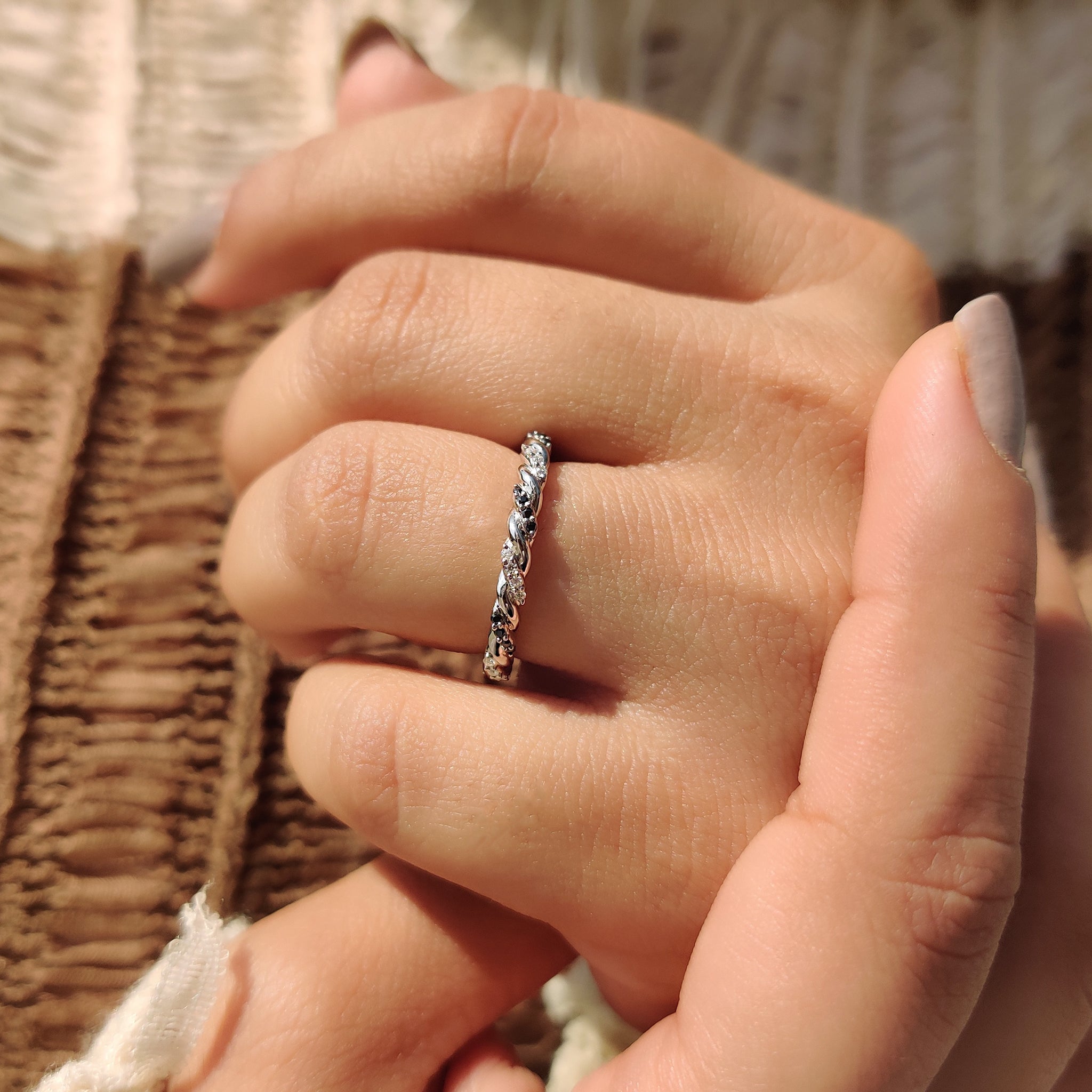 Moissanite wedding band in unique twisted setting.
