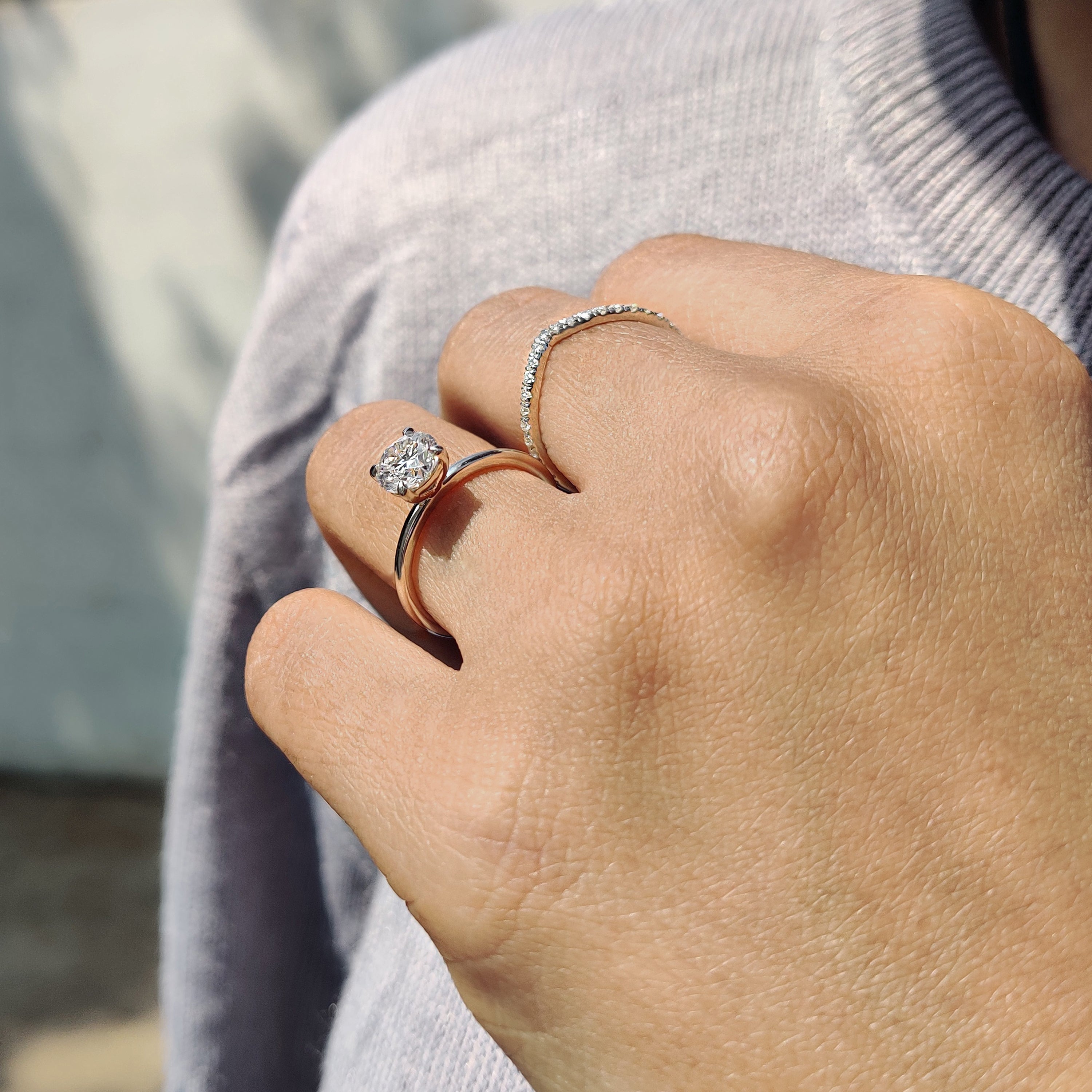 Round cut moissanite ring set in a 4 prong claw setting with a v shaped band.
