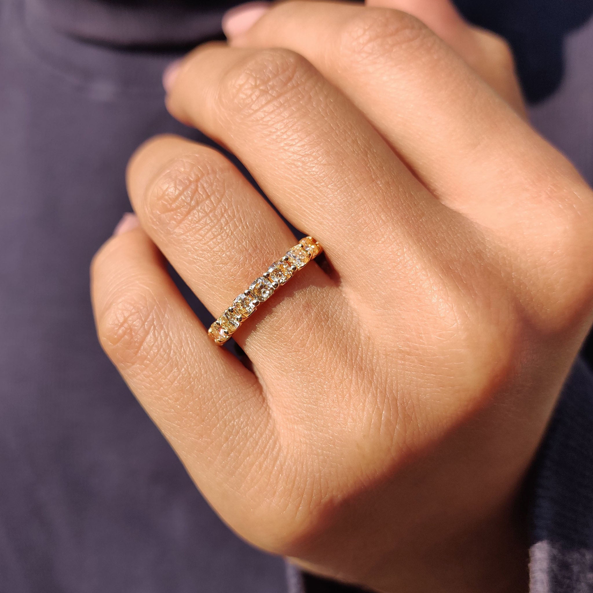 Promise band with soft yellow cushion cut moissanite in a classic full eternity layout.