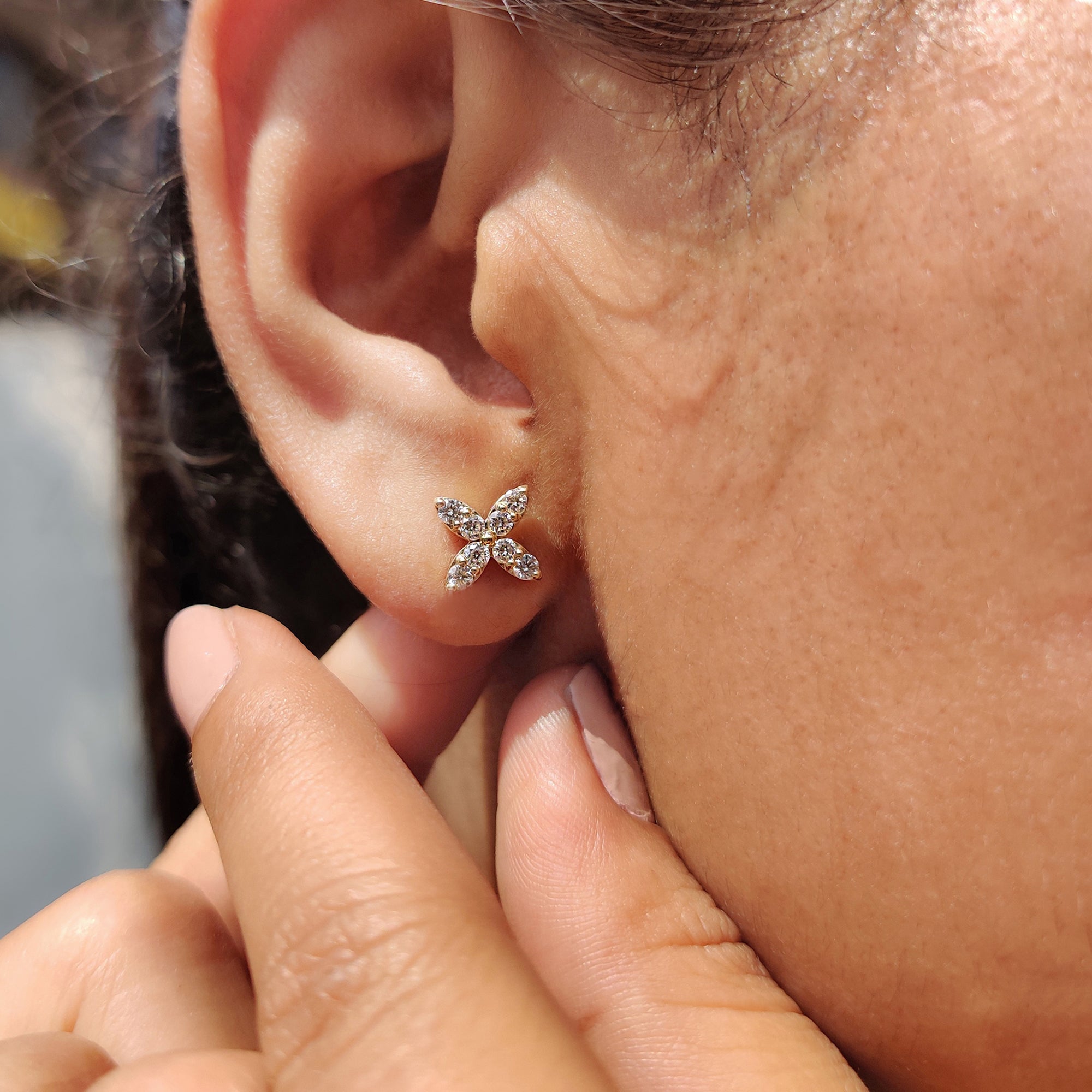 Minimalist yellow gold earrings with lab grown diamonds.