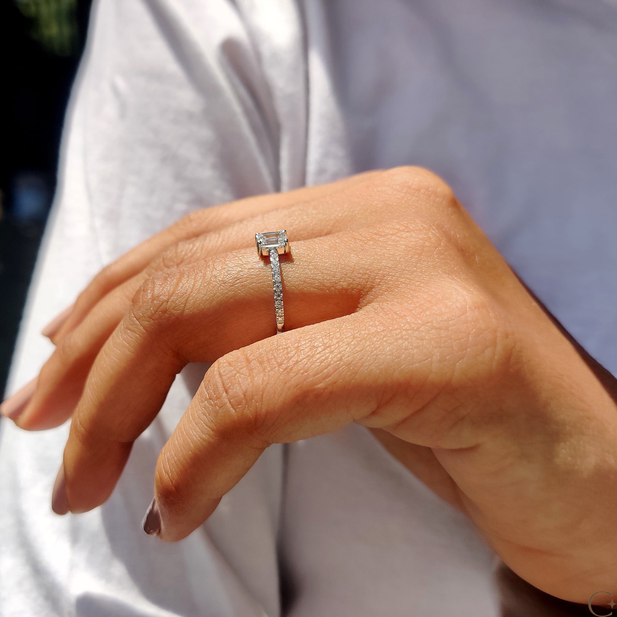 Classic emerald cut diamond set in a pave setting ring.
