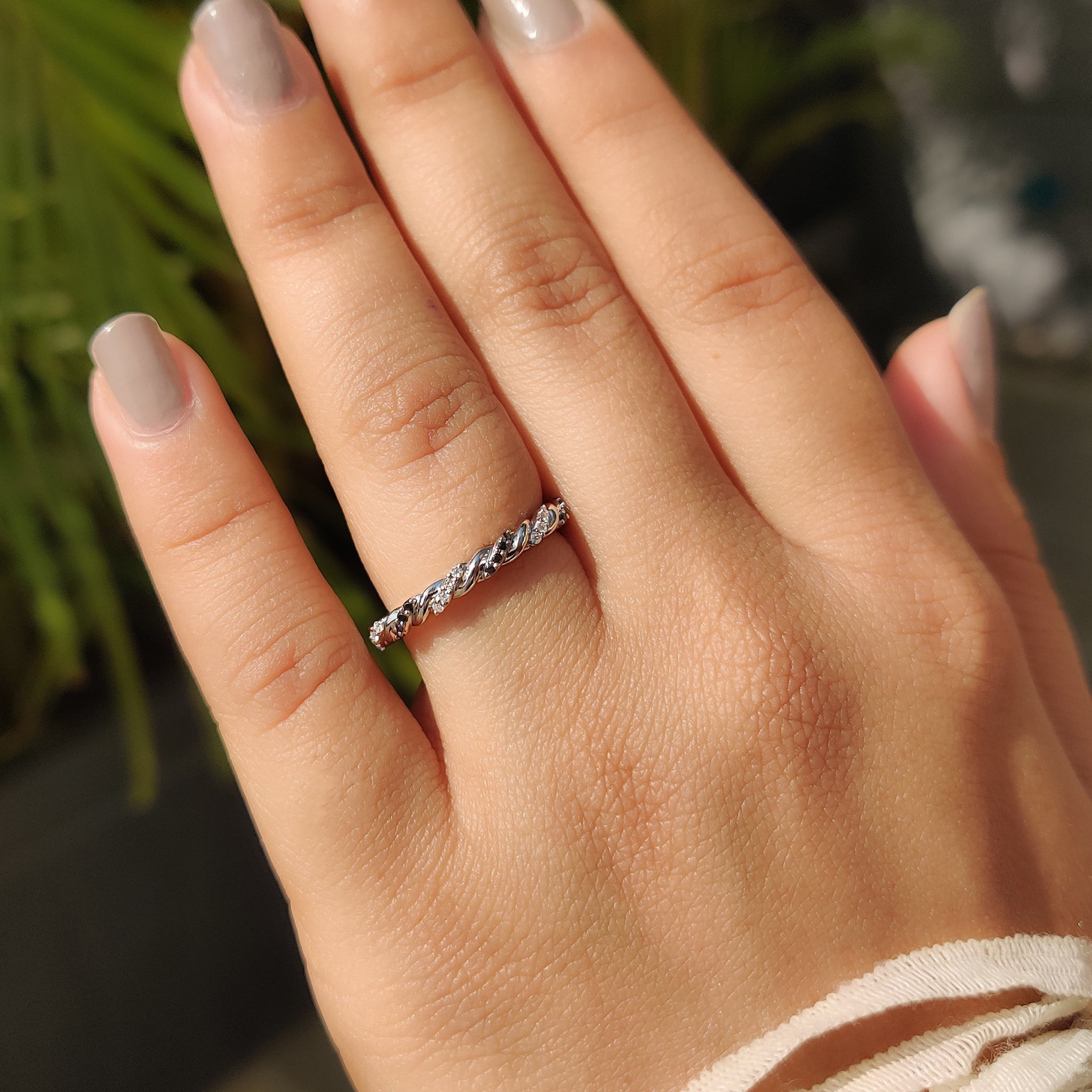 White gold wedding band with round cut stones.
