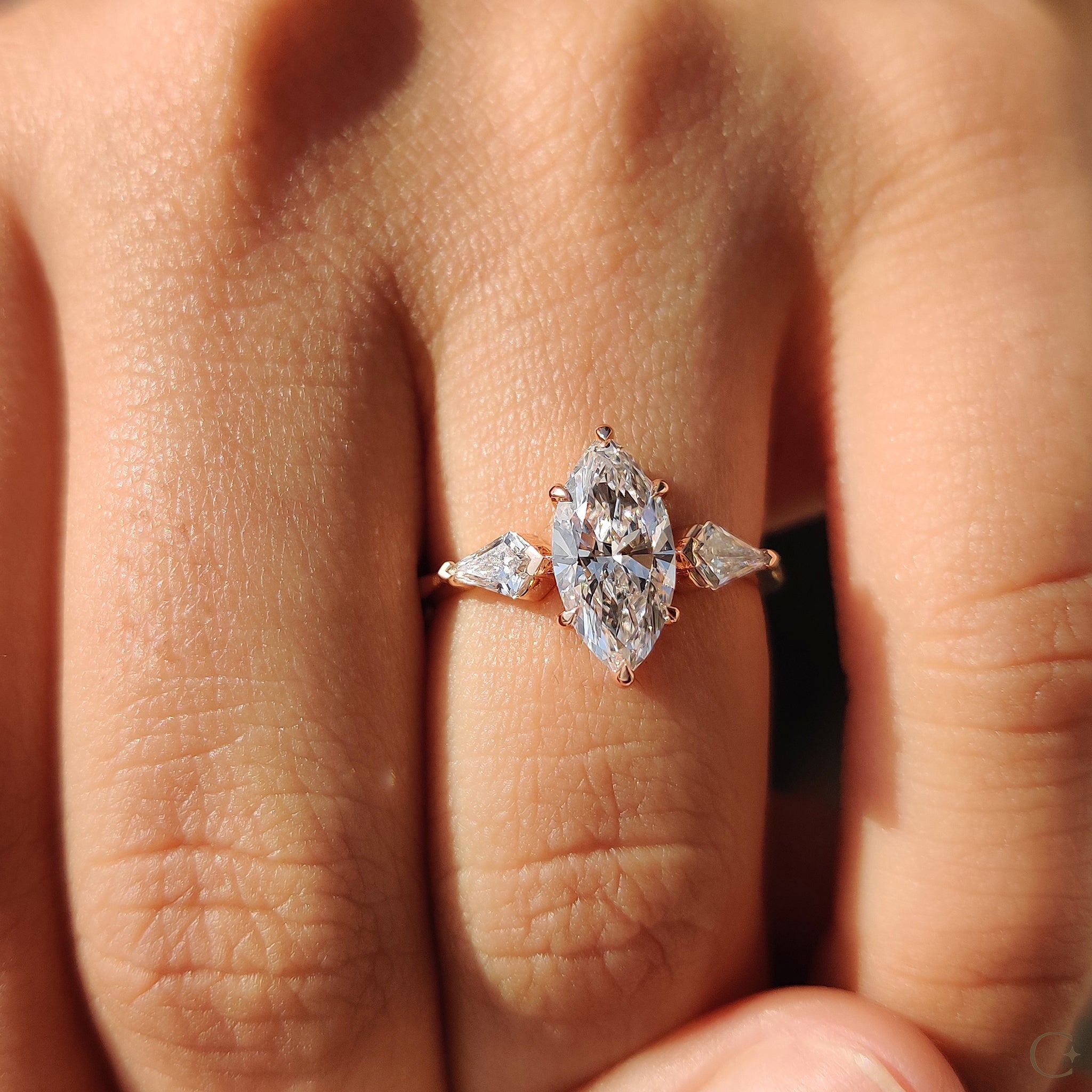 Two side stone kite cut diamond ring for extra sparkle.
