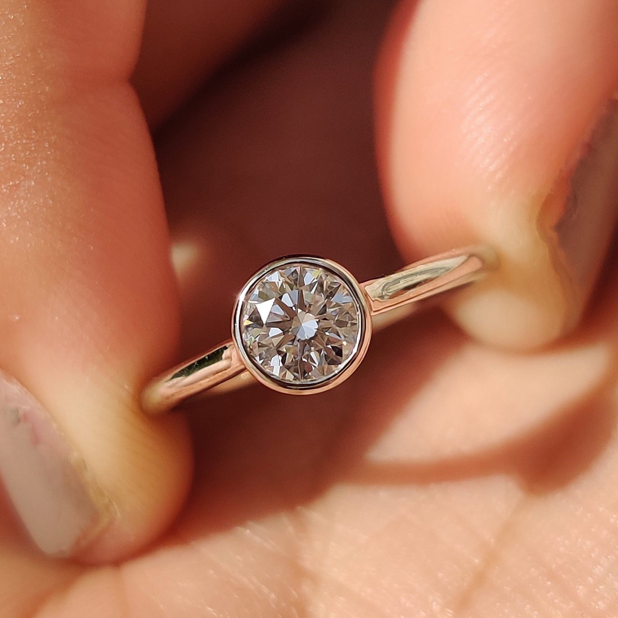 Bezel set diamond ring with secure and sleek setting.
