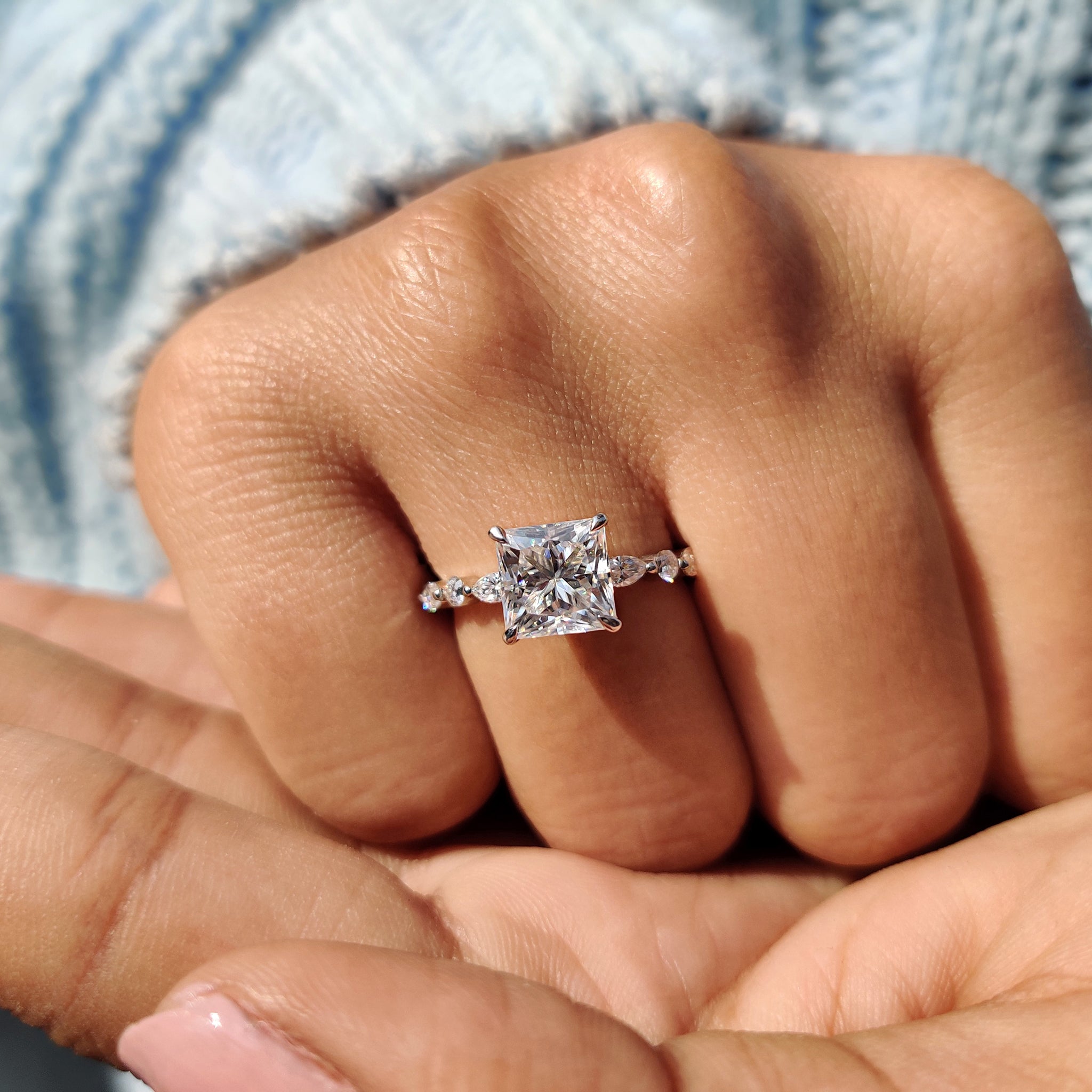Marquise and round side stones frame the center.
