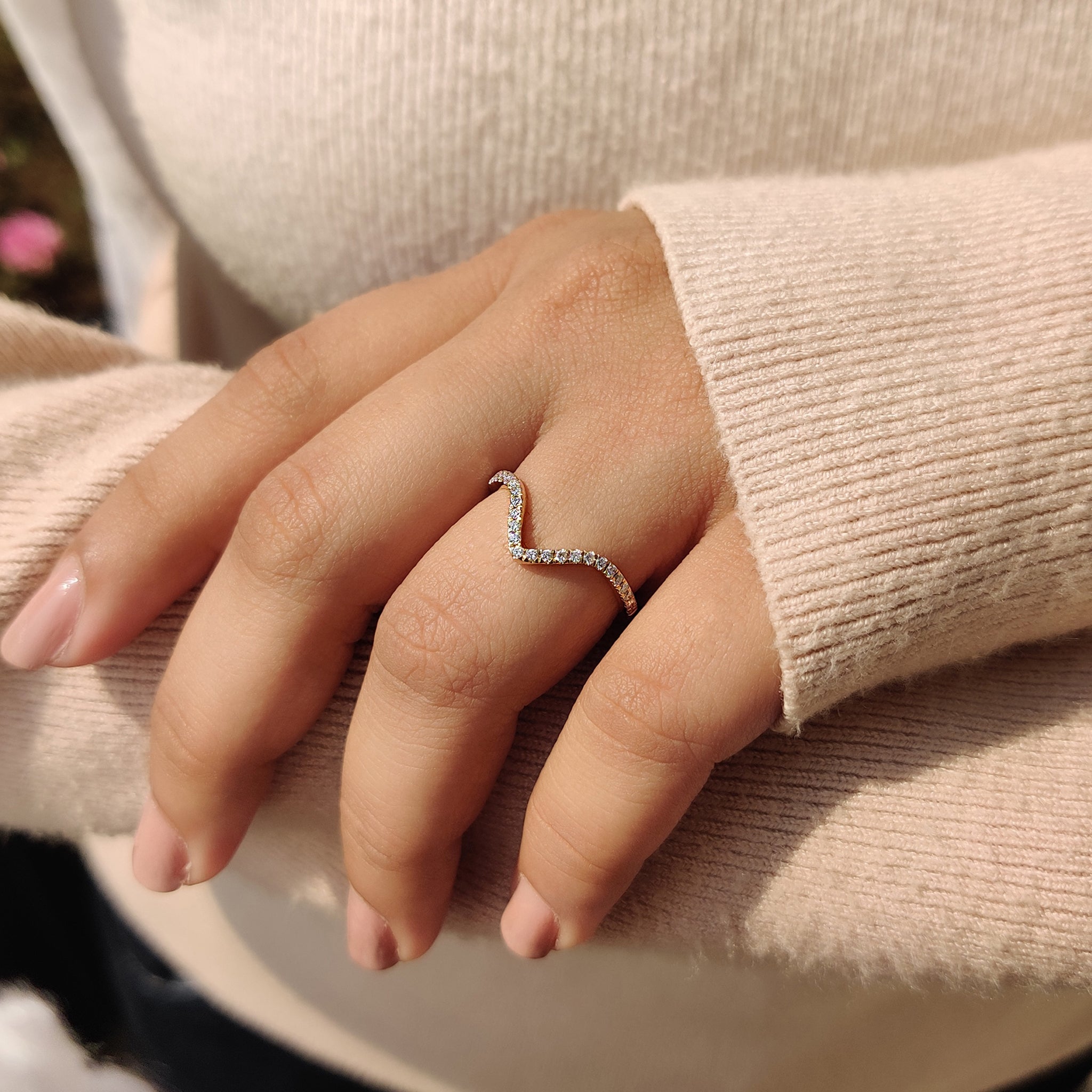 Chevron diamond ring with sparkling accents, ideal for special occasions.

