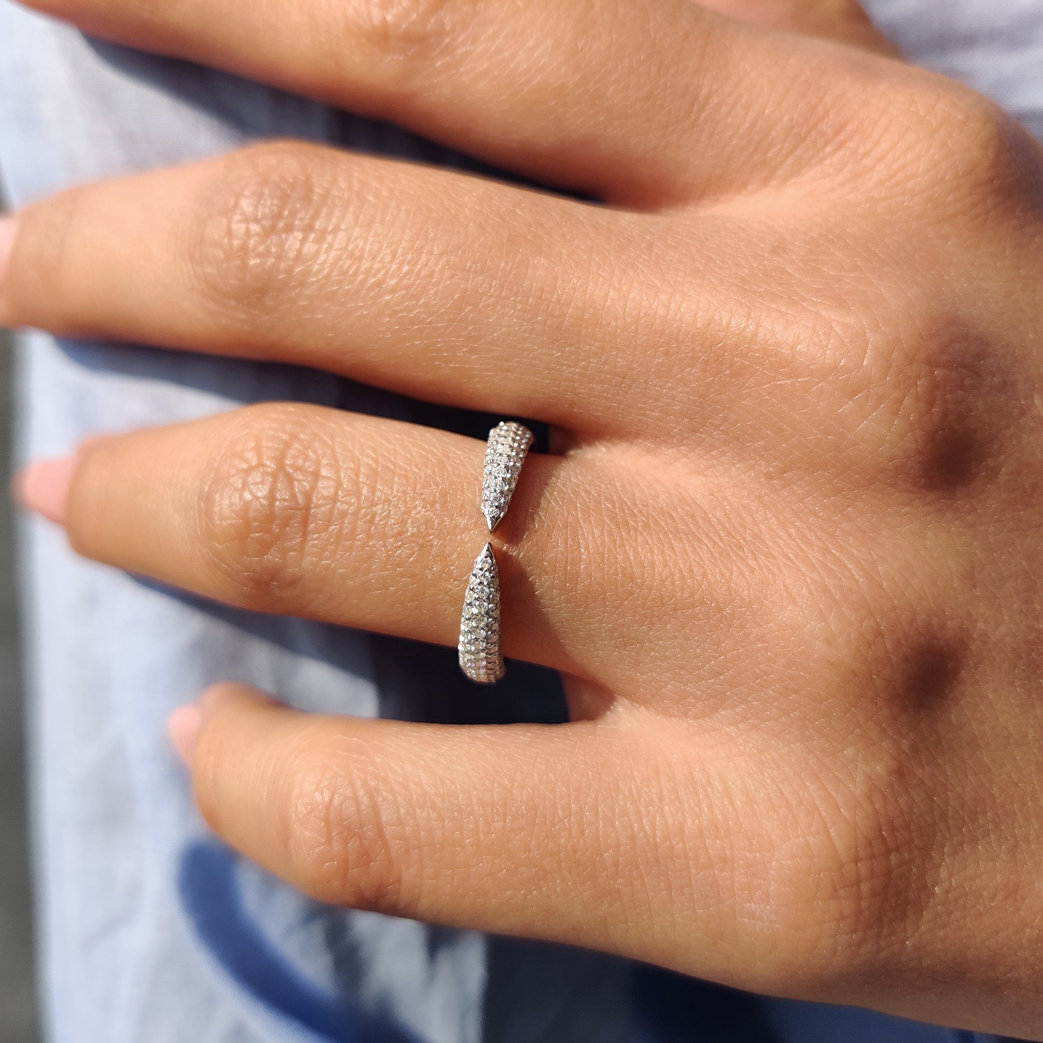 Half eternity band featuring round cut moissanite stones set halfway around the band.