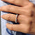 Half eternity band featuring round cut moissanite stones set halfway around the band.