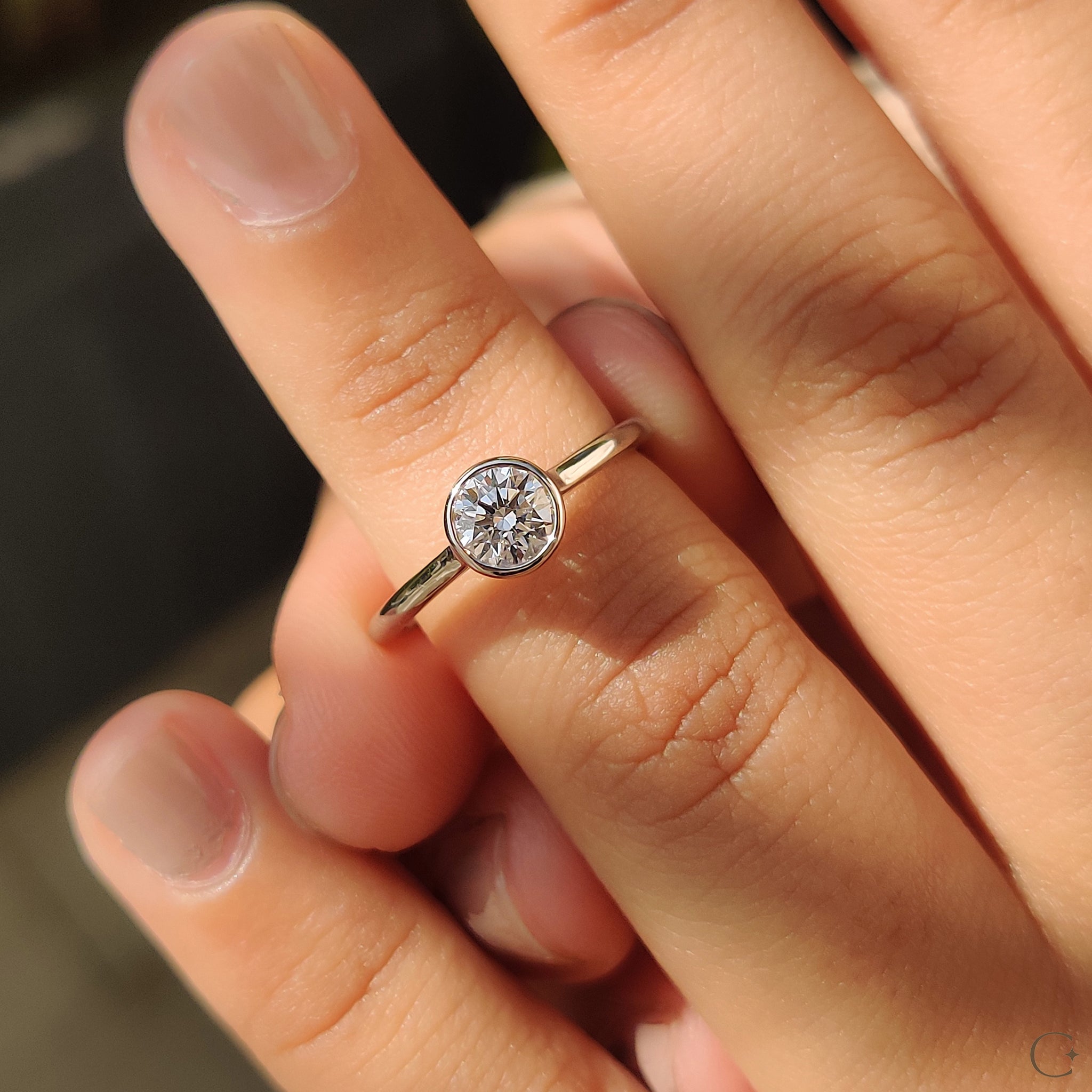 Bezel set diamond ring with secure and sleek setting.
