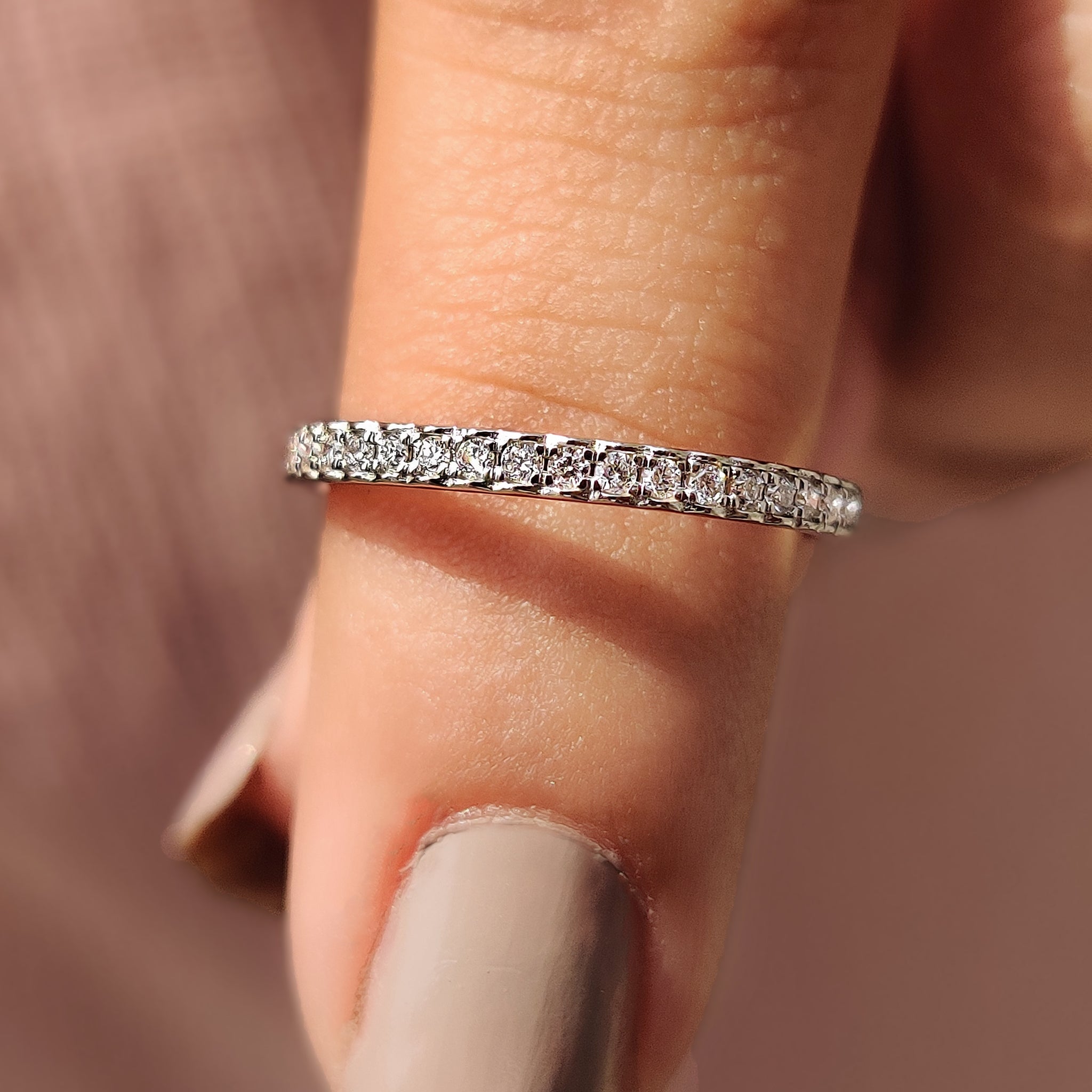 White gold diamond band with round-cut diamonds.
