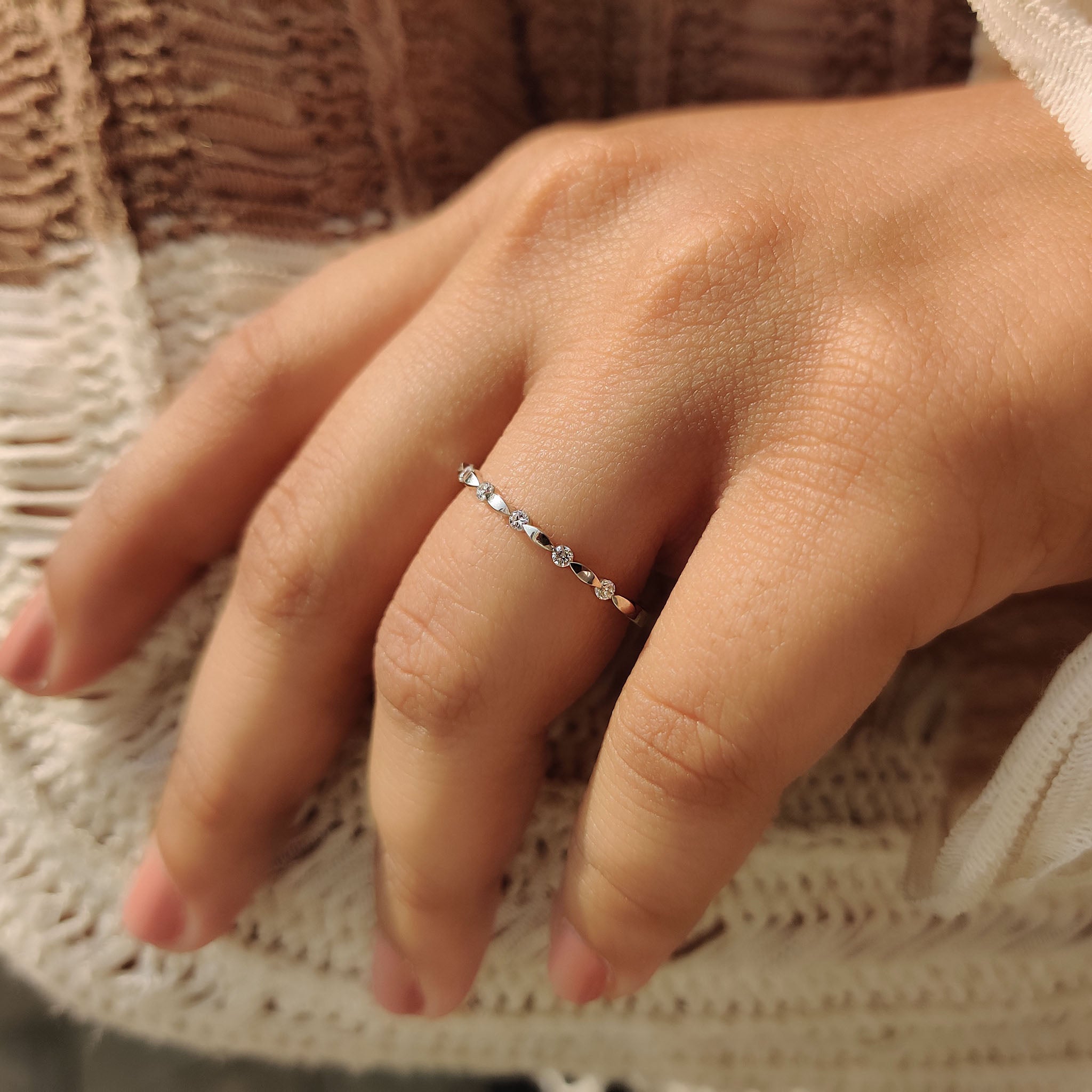 Handmade jewelry wedding band with round cut diamonds and white gold band.
