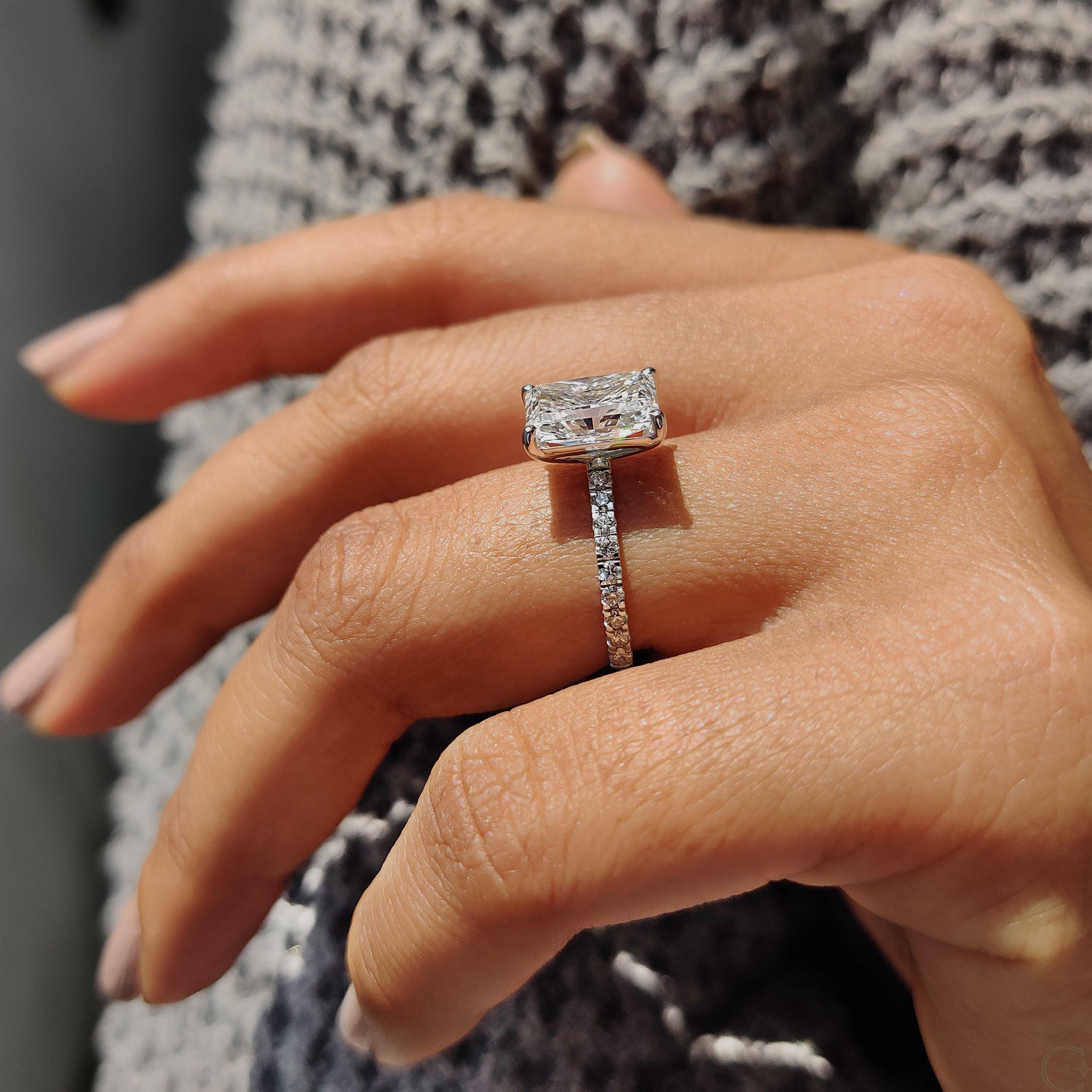 Round cut pave engagement ring with intricate detailing.
