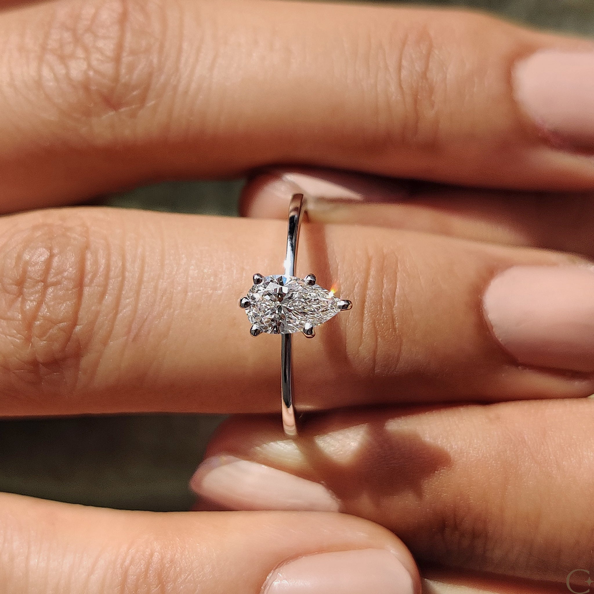 Tapered shank engagement ring with intricate diamond details.