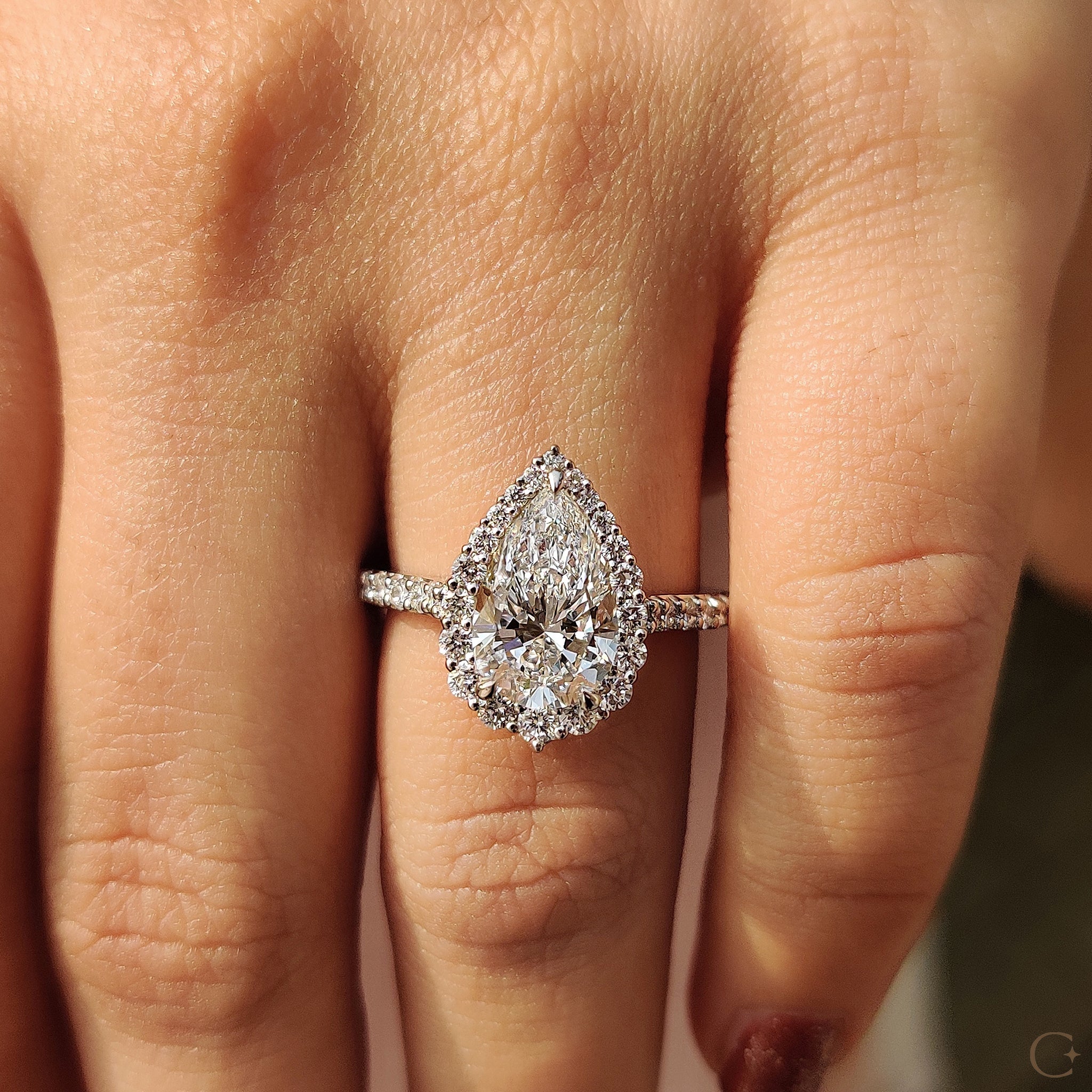 Halo setting with a beautiful pear cut diamond.
