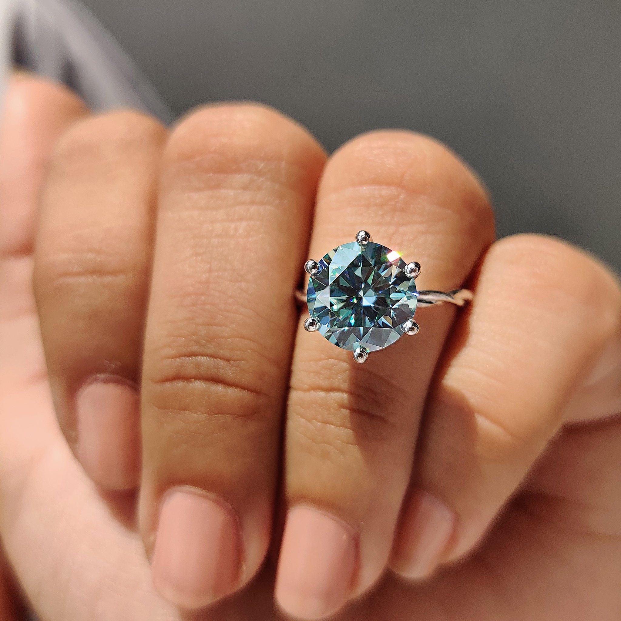 Moissanite engagement ring in a solitaire style with soft curves.

