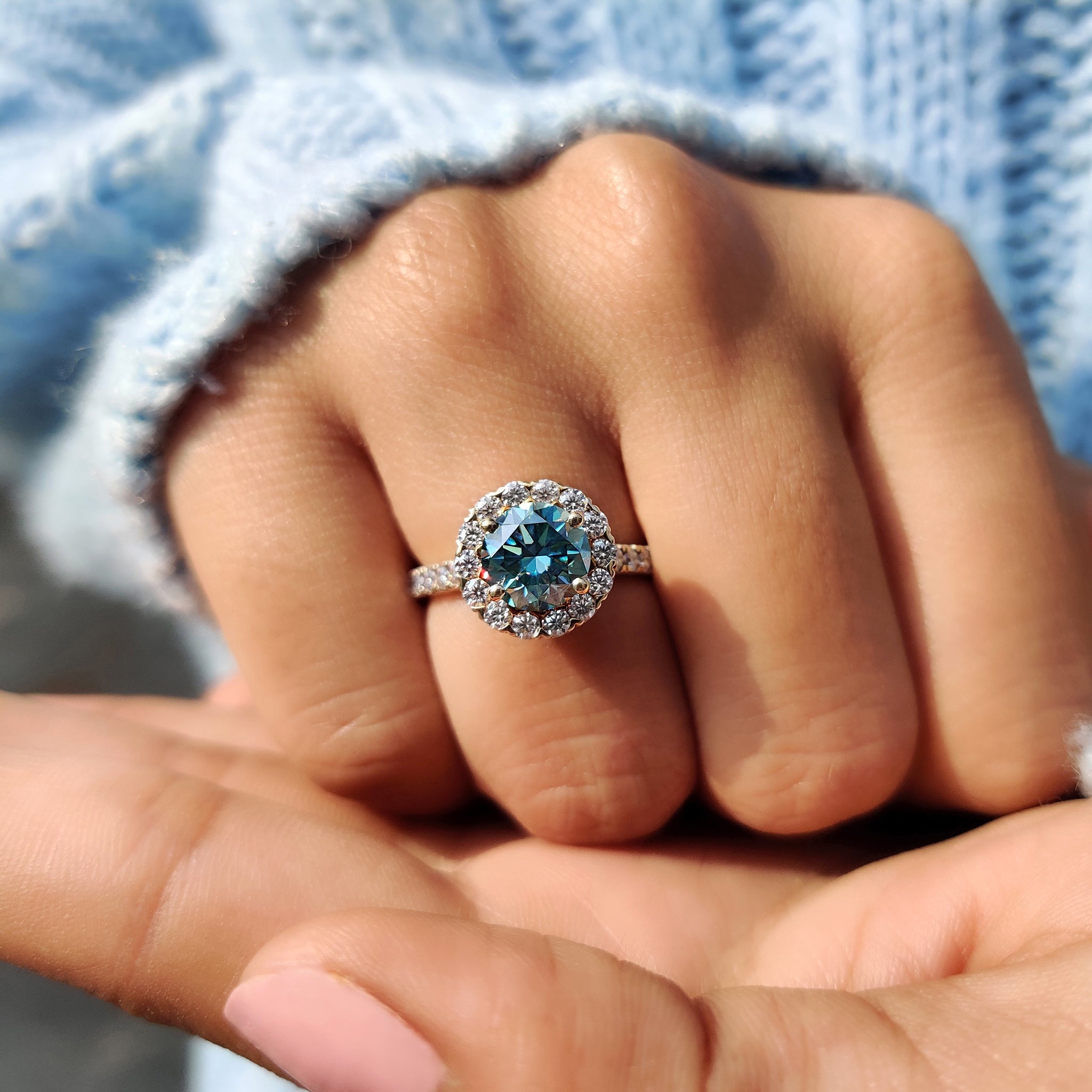 Cyan blue moissanite ring adding a vibrant pop of colour.