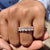 Oval cut moissanite wedding band featuring full eternity layout in yellow gold.