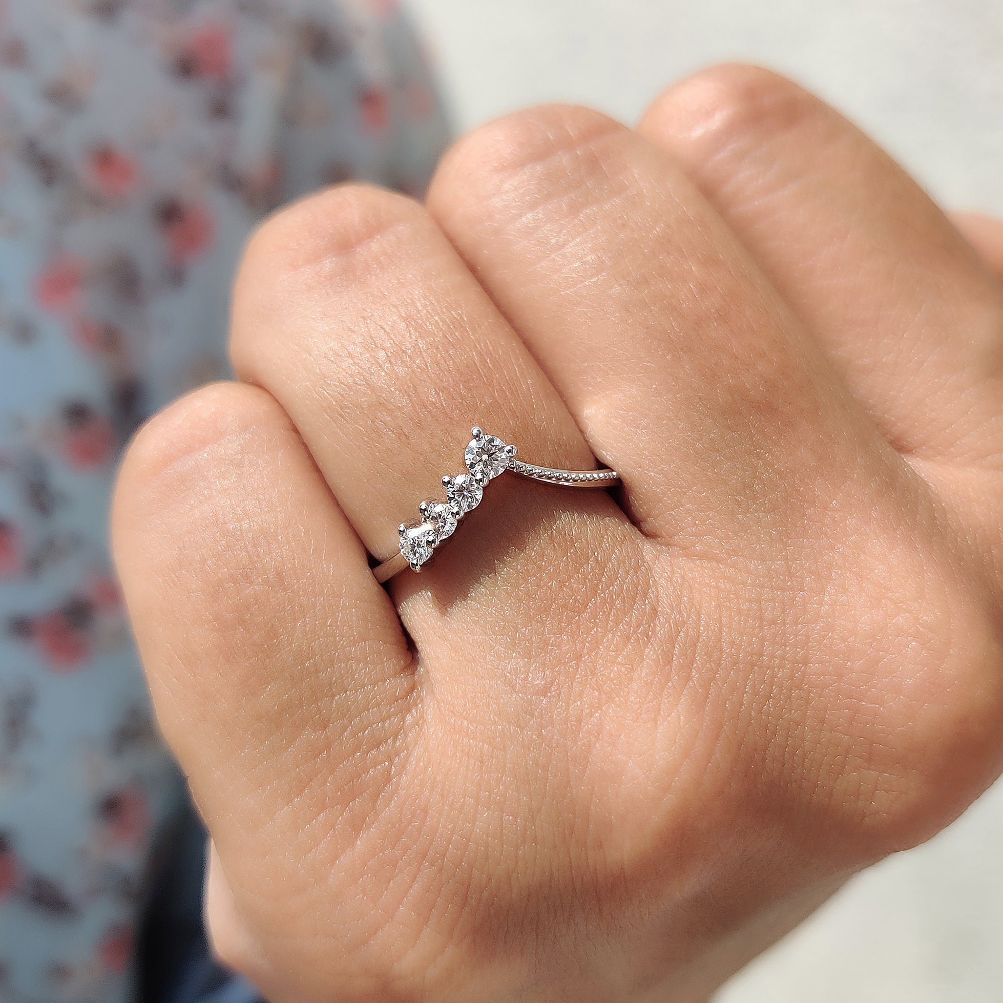 Delicate chevron stacking ring with round cut moissanite.