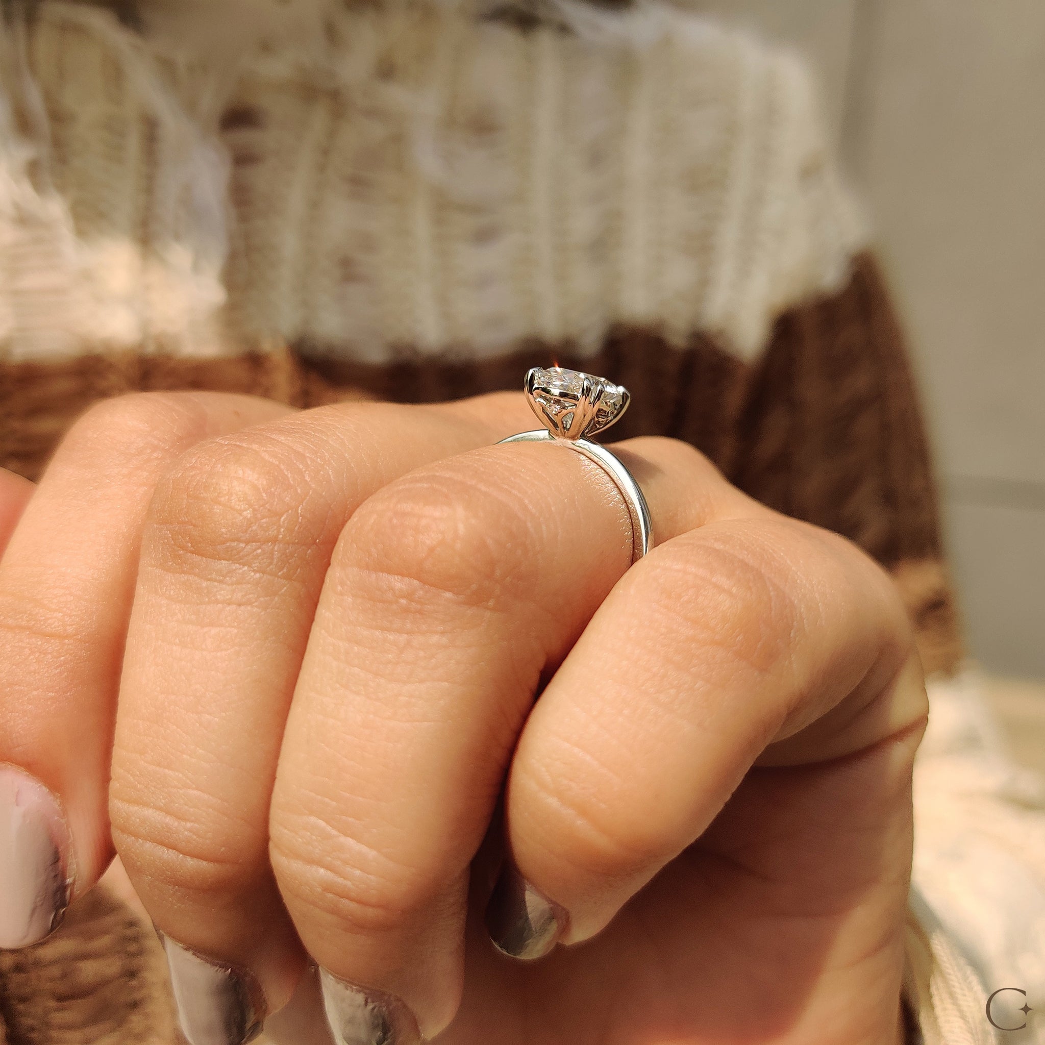 Custom engagement ring featuring a unique oval cut diamond.
