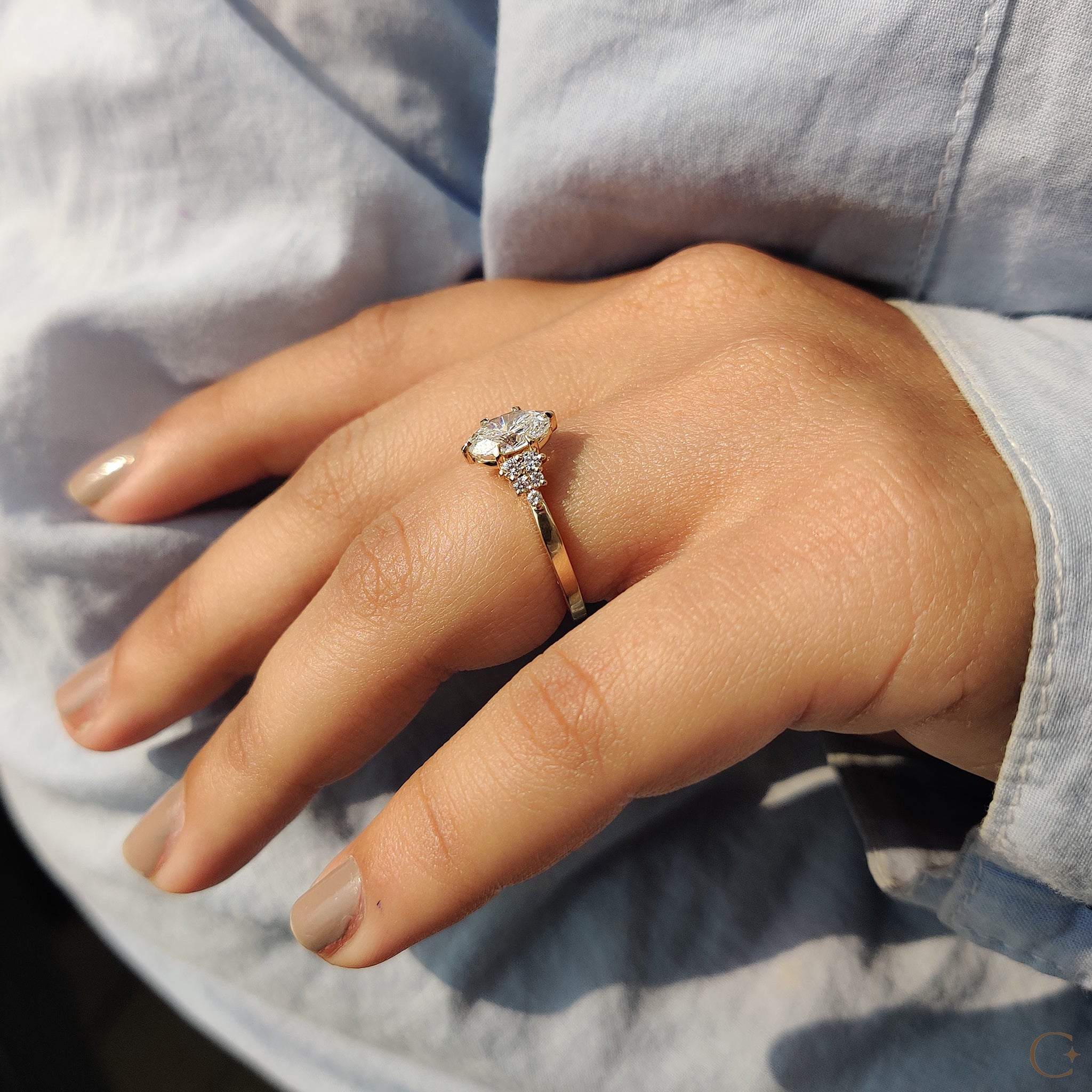 Round side stones enhancing the center diamond.