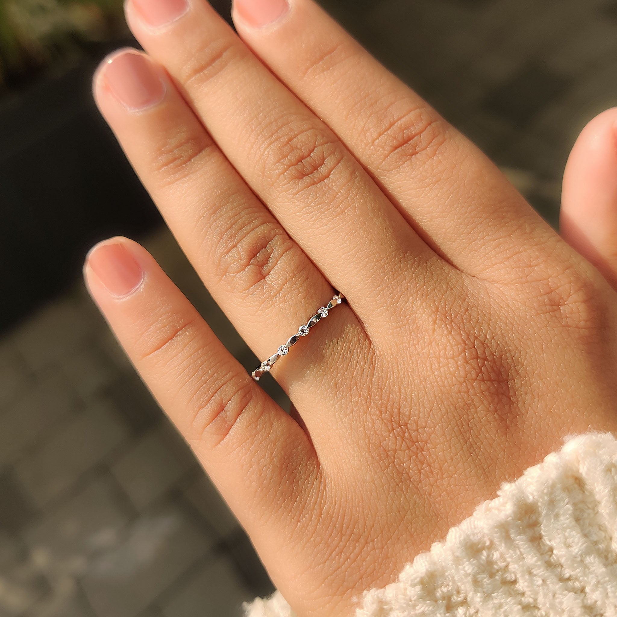 Half eternity wedding band with distance pave and stackable white gold style.
