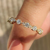 Carat diamonds wedding band highlighted on a marble surface.
