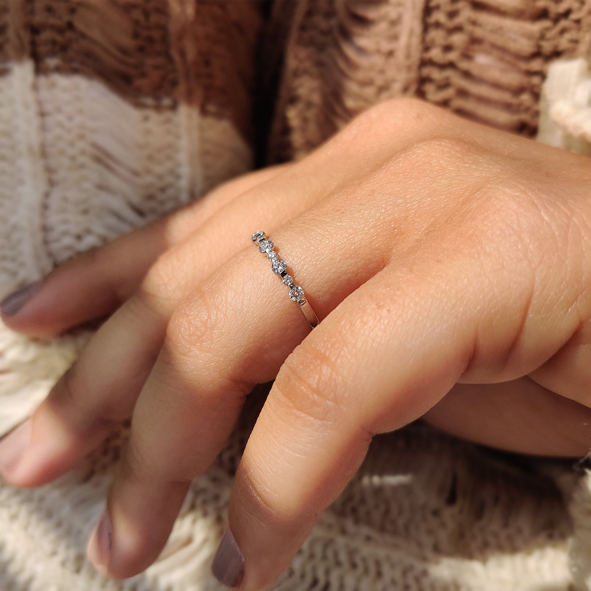 Round Cut Diamond set in a half eternity wedding band.
