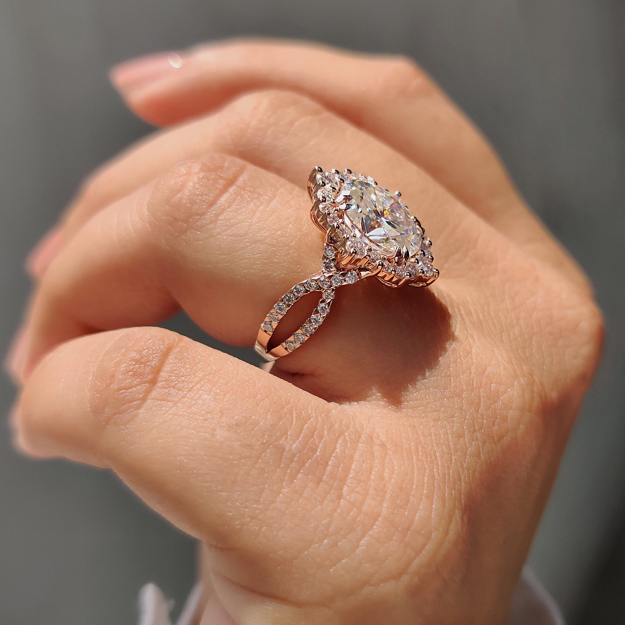 Round halo ring highlights the center with a surrounding stone circle.
